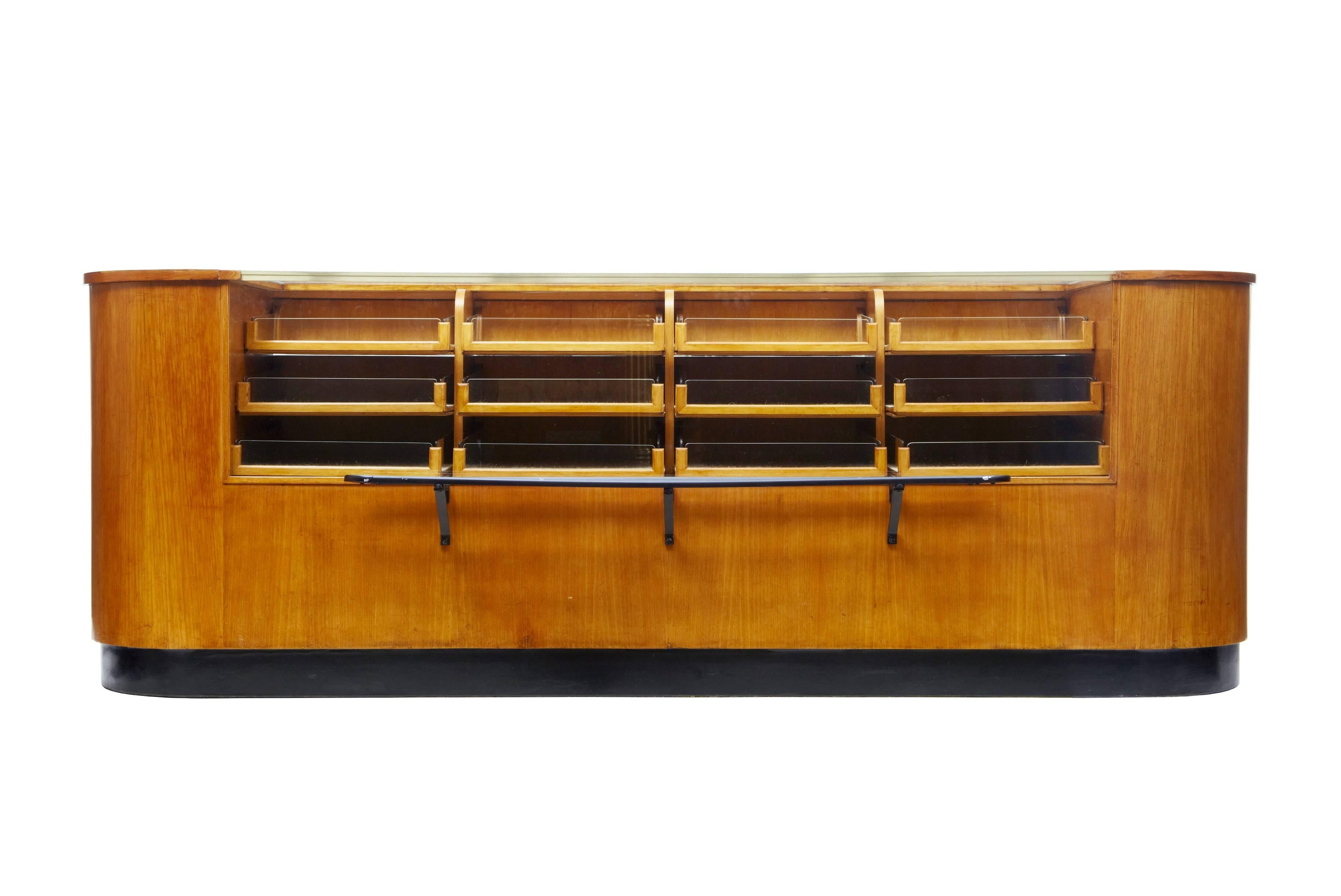 Here we have a stunning Art Deco shop display which is among the finest you will find on the internet, circa 1920.
Shaped oak ends with ebonized plinth to the front which drawers your attention to the glazed front and layered drawers.
To the