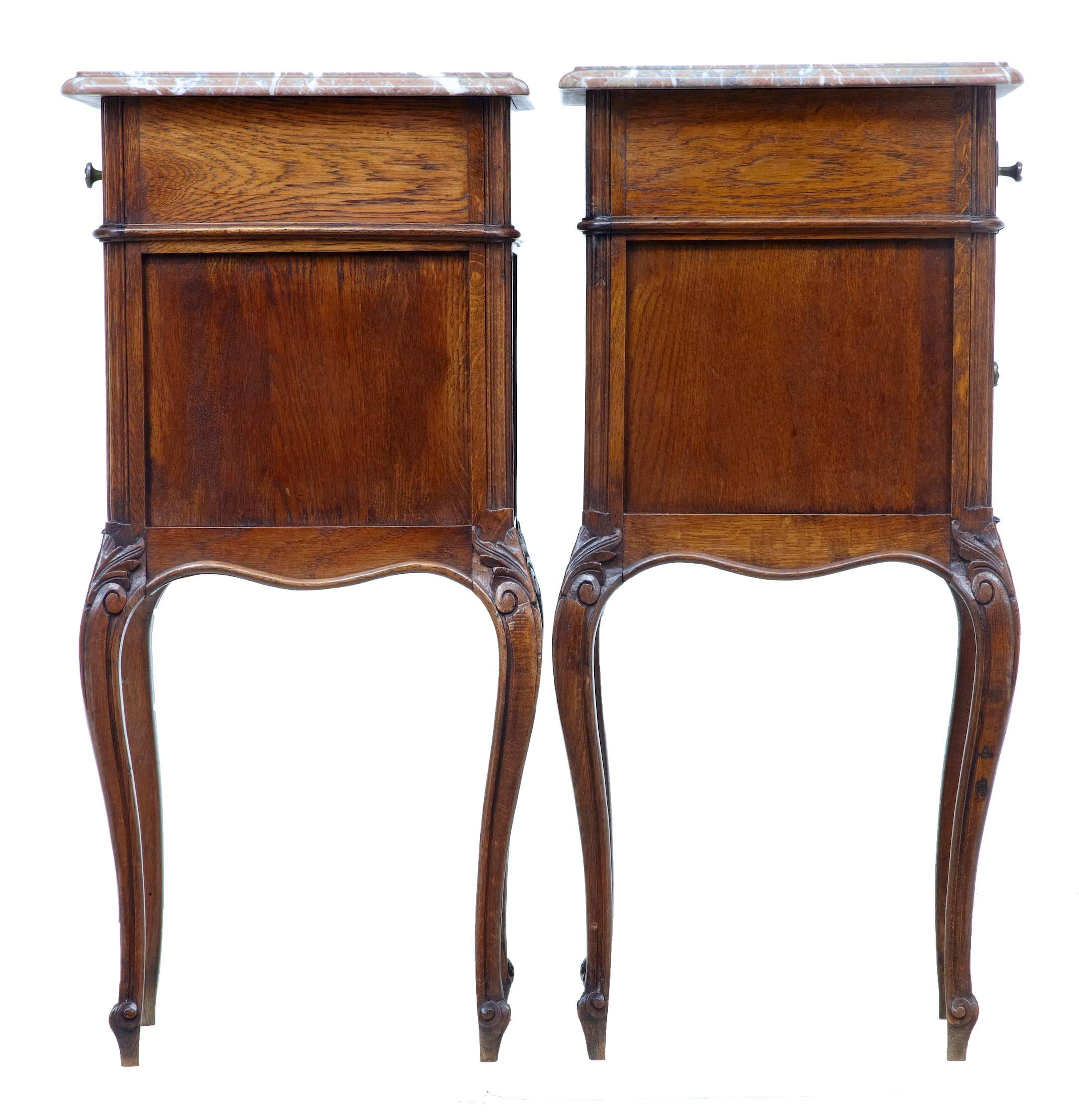 Pair of French 19th century bedside tables, circa 1890.
With pink/grey marble tops which are fixed into place.
Single drawer over single door pot cupboard.
Good color and patina

Measures: Height 34