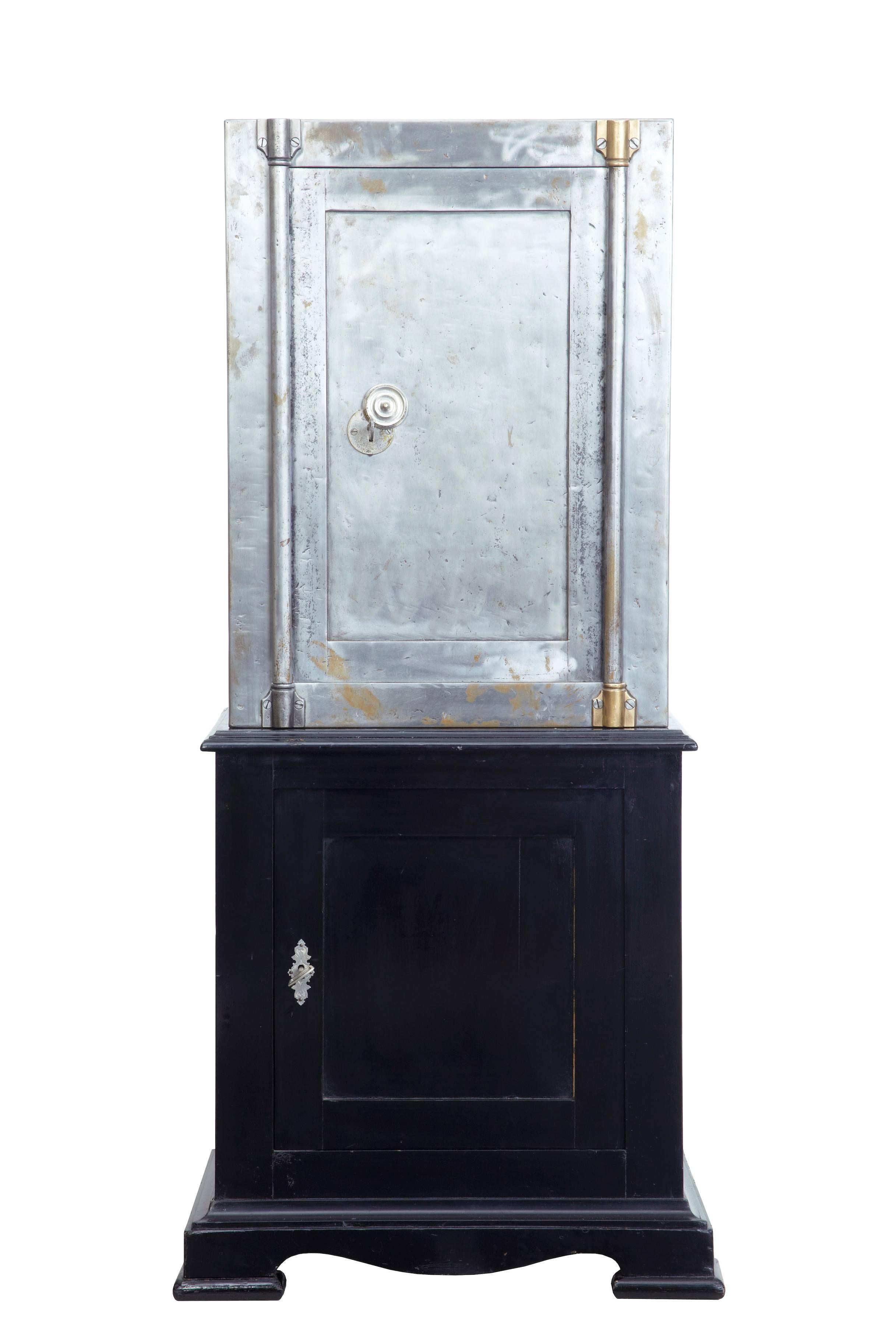 Late Victorian safe on black lacquered cabinet, circa 1890.
Safe has been stripped of paint and polished to show the steel surface.
Original key opens the door to original interior with brass bound fitted lockable drawer.
Stands on pine black