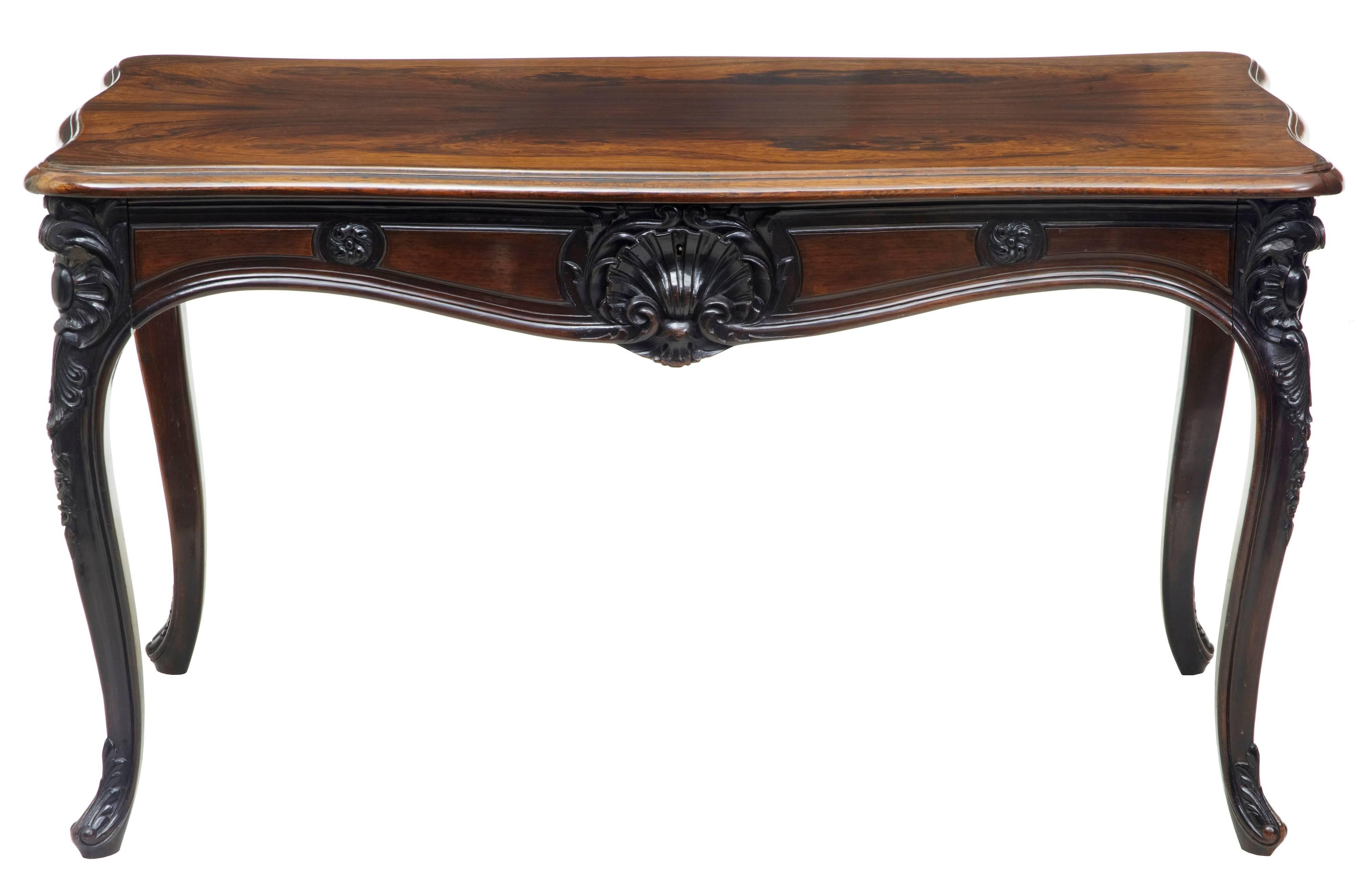 Good quality carved rosewood occasional table or desk, circa 1880.
Beautiful grain and color to this table that could be used as a sofa or hall table or a ladies desk.
Single large drawer to the front with partitions.
Shaped top edge, carving