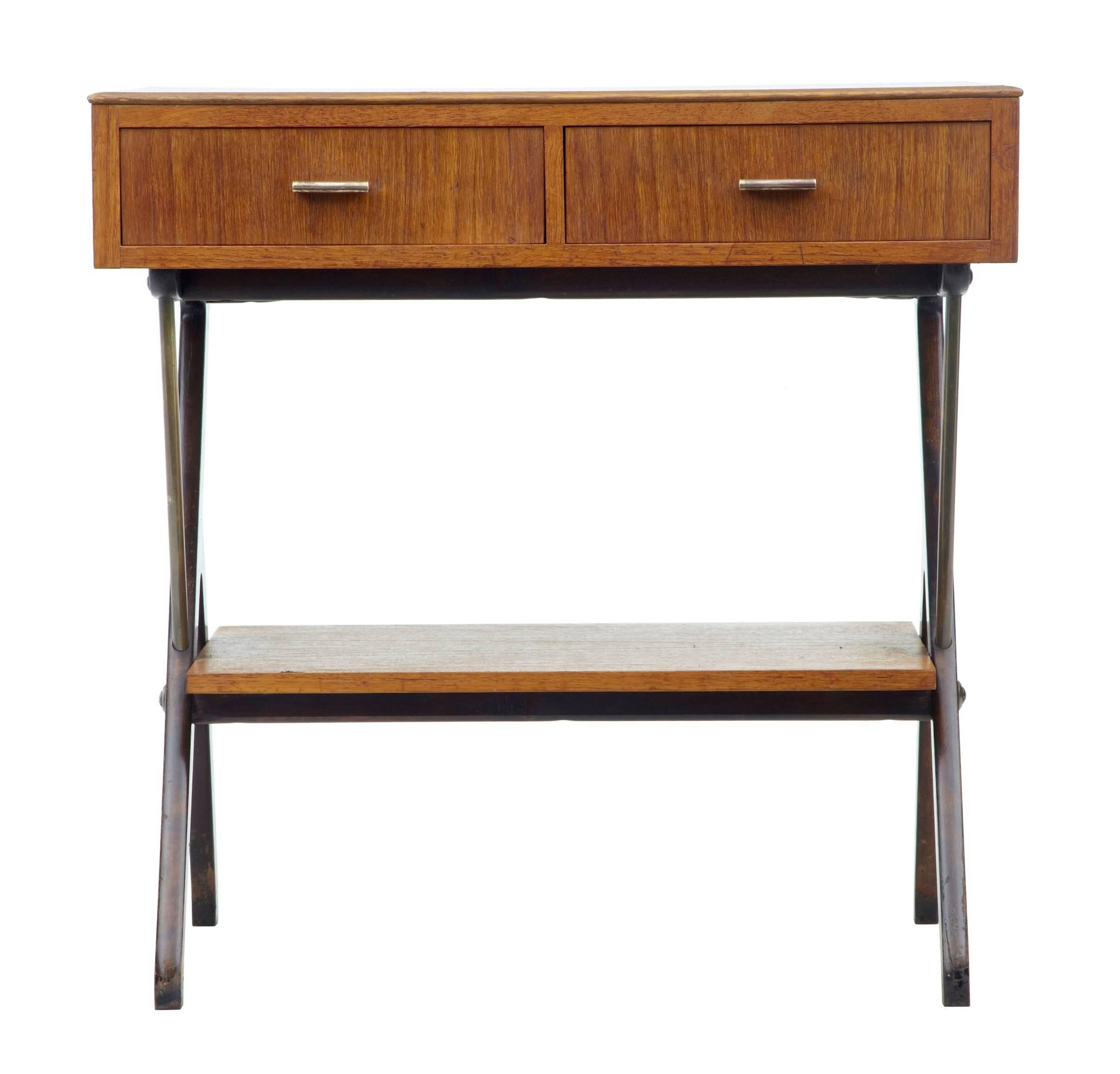 Teak side table with two front drawers.
Formica inlaid top.
Standing on Y frame legs, united by a storage shelf.

Measures: Height: 24