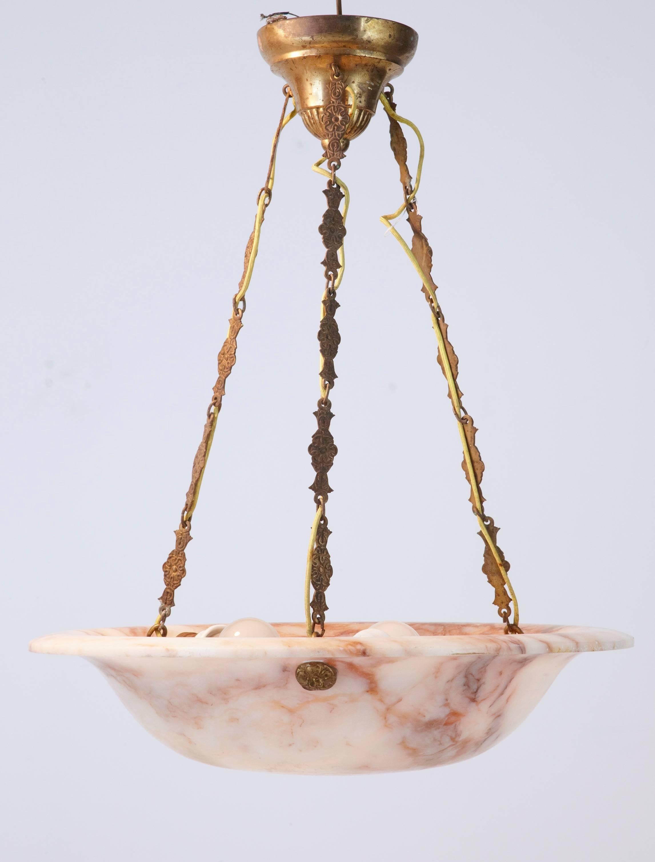 Good quality Art Deco ceiling light, circa 1920.
Beautiful pink veining flowing through the bowl.
Three bulb fittings around the bowl. Suspended by three decorative brass chains which lead up the ceiling rose.
Some marks to the bottom of the