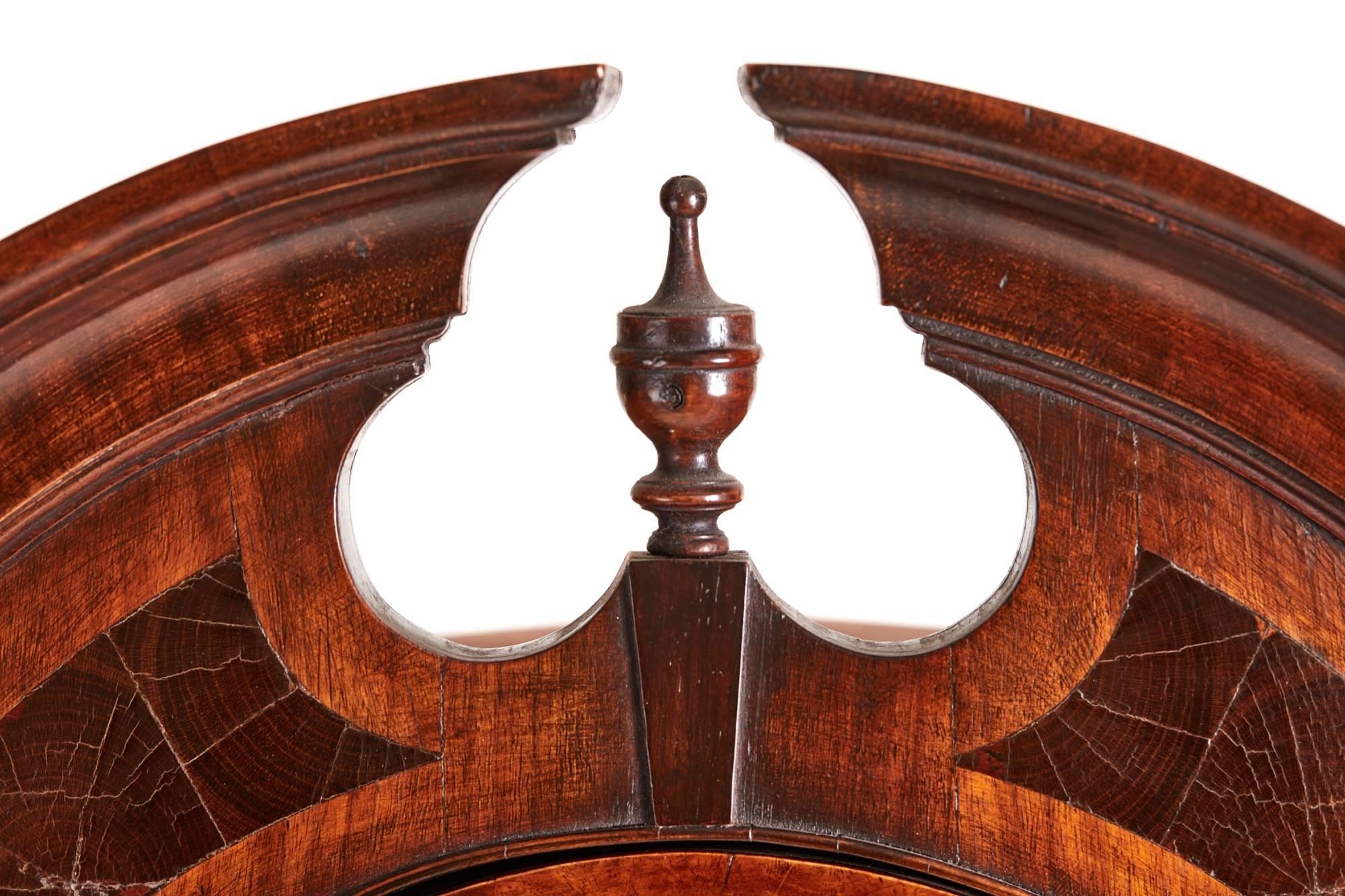Queen Anne style burr walnut and oyster wood corner cabinet, with a shaped moulded pediment and oyster wood inlay, turned finial to the centre, single astral glazed door, the interior with two shelves, the base having a single door inlaid with