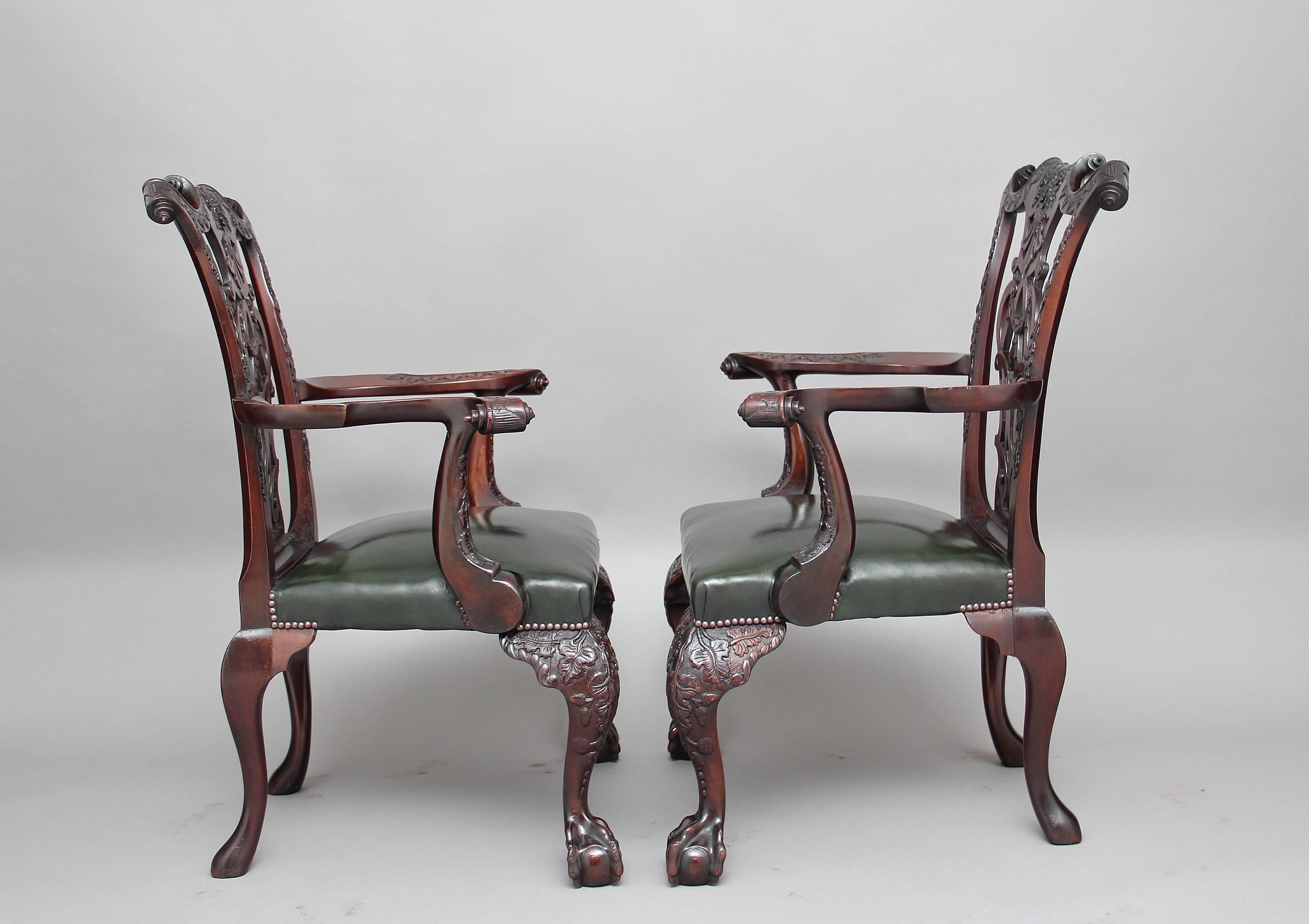 A remarkable pair of 19th century profusely carved mahogany armchairs in the Chippendale style, superb quality and lovely dense timber, the carved supports decorated with acorns and flower foliage and having craved scrolls at the top either side, at