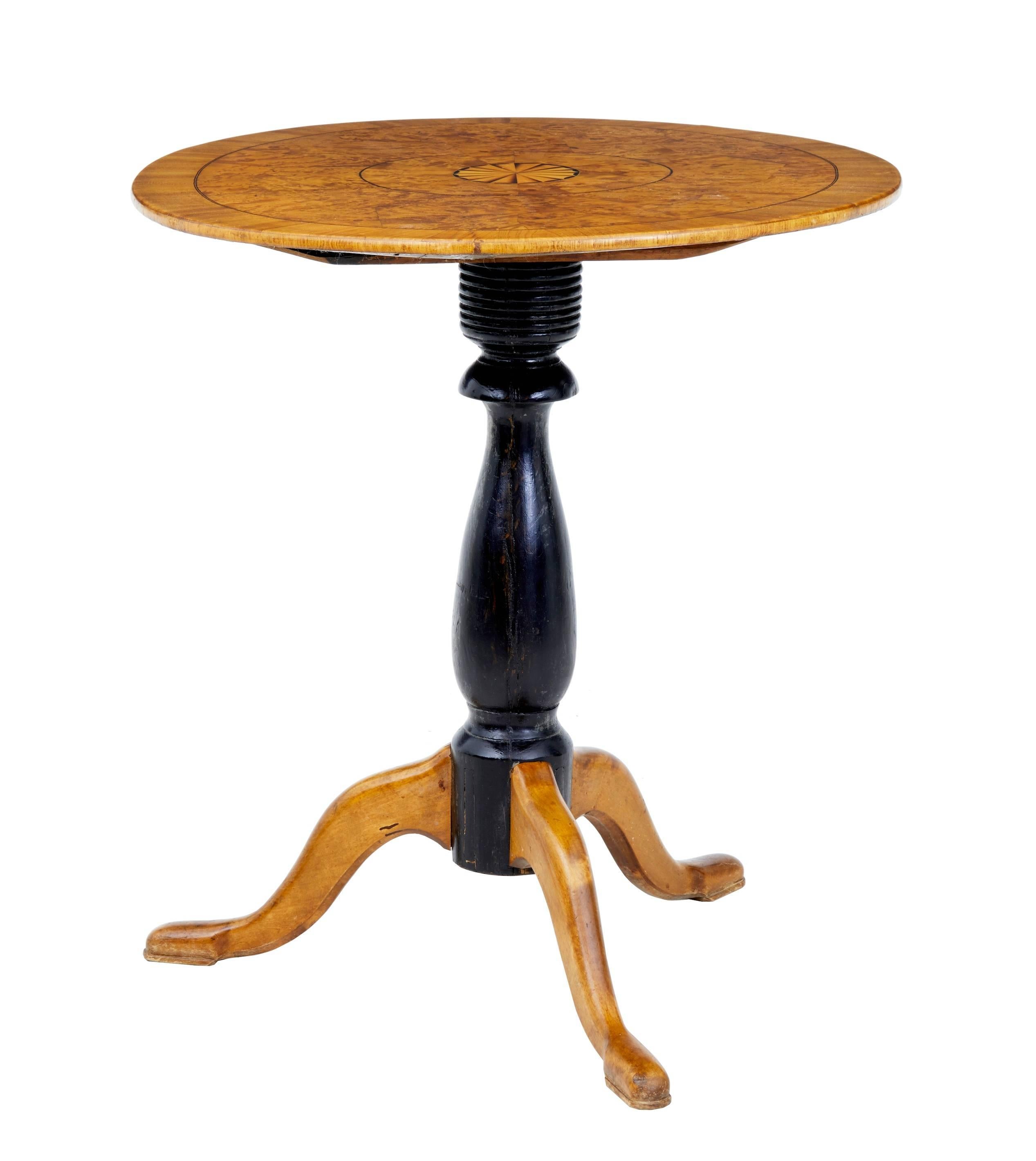 Fine quality elm root oval table, circa 1860.
Beautifully inlaid top with stringing and inlay.
Rich and vibrant in color.
Standing on a ebonized tripod base, terminating on pad foot.

Measures: Height 28 1/2