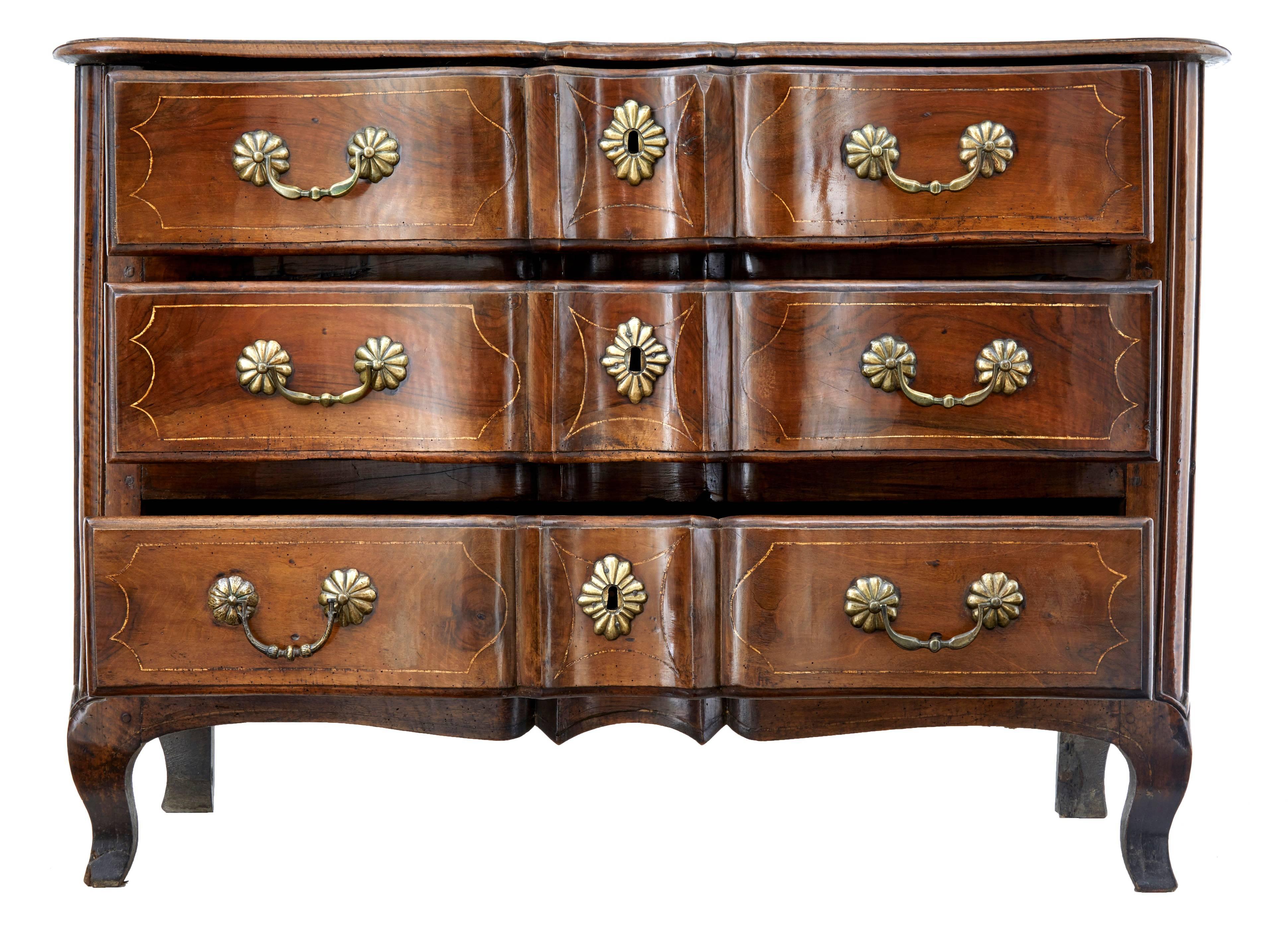 Rare piece of French 18th century Furniture, circa 1740.
Beautiful walnut three-drawer commode.
Stringing to top and drawer fronts. Serpentine and shaped front with original handles and escutheons.
Good original color and patina.

Evidence of