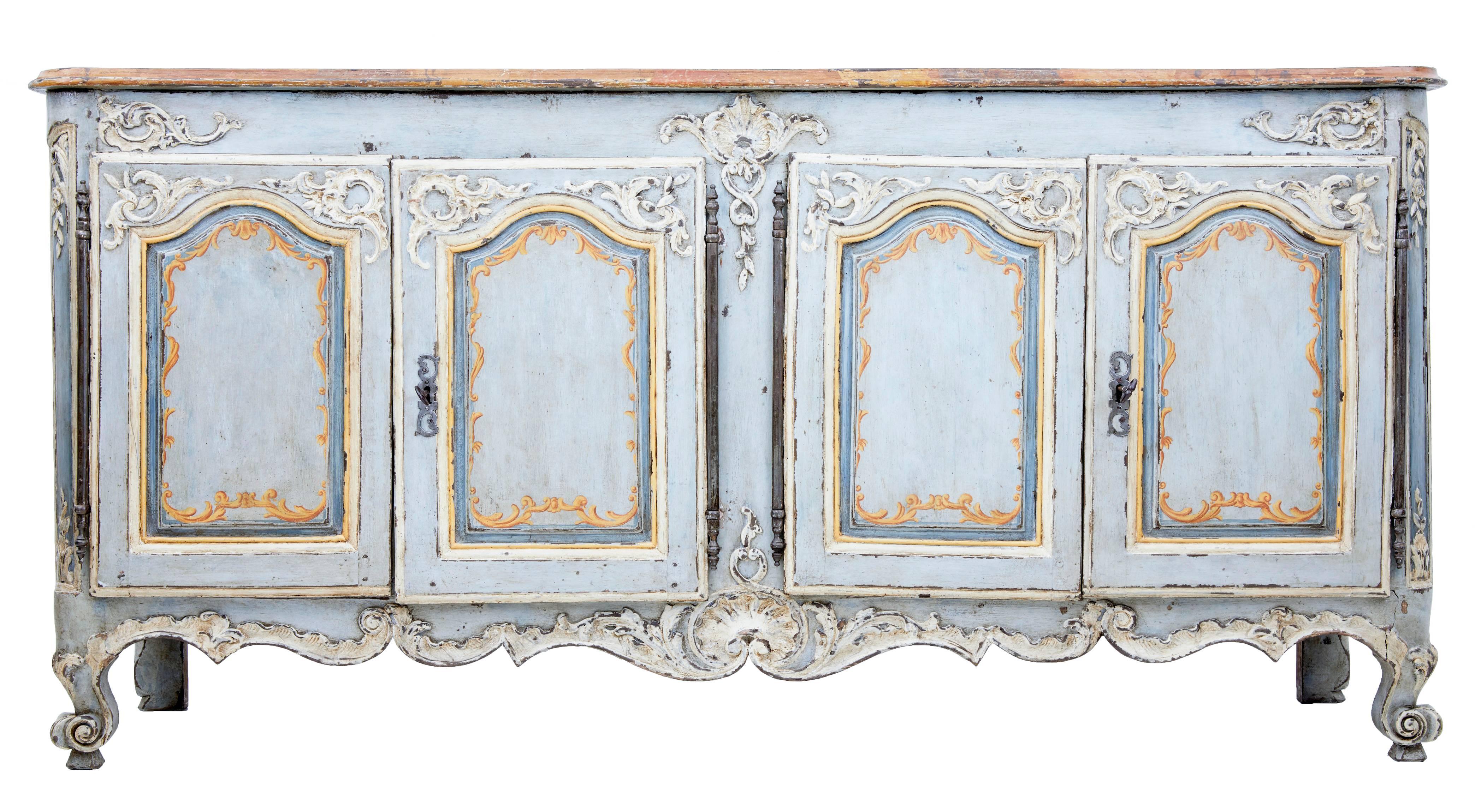 Beautifully decorated French oak dresser base, circa 1770.
Original paint with later orange florals on the doors, carving painted in white to contrast with the base colour.
Stumbled top with painted florals and swags in the centre.
Double doors