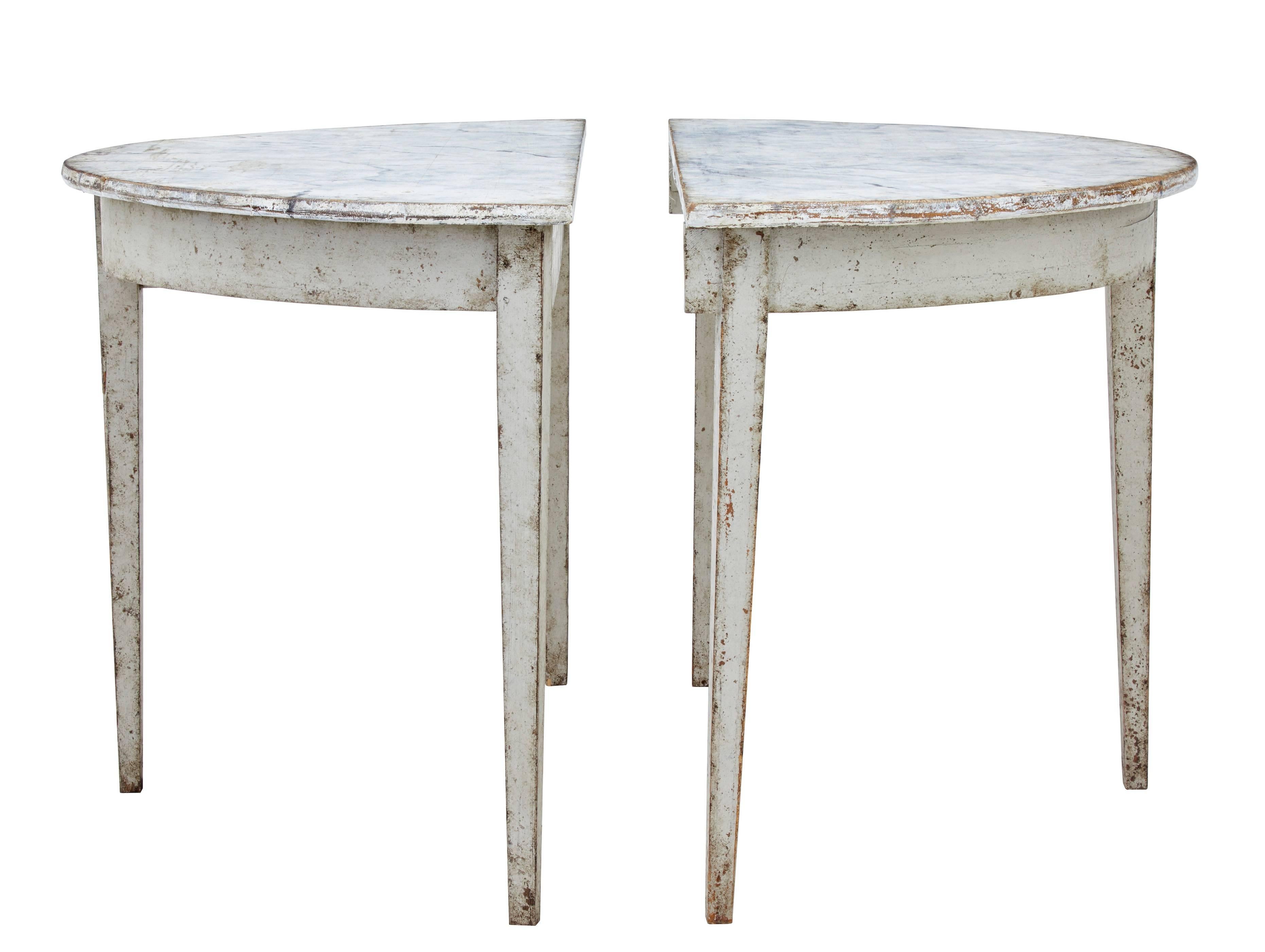 Pair of demilune tables, circa 1870.
Faux marble painted top which is now in a distressed finish.
Each pine table is standing on three tapering legs.
Could be used as a pair of occasional tables or form a round table.
Later paint.
One small