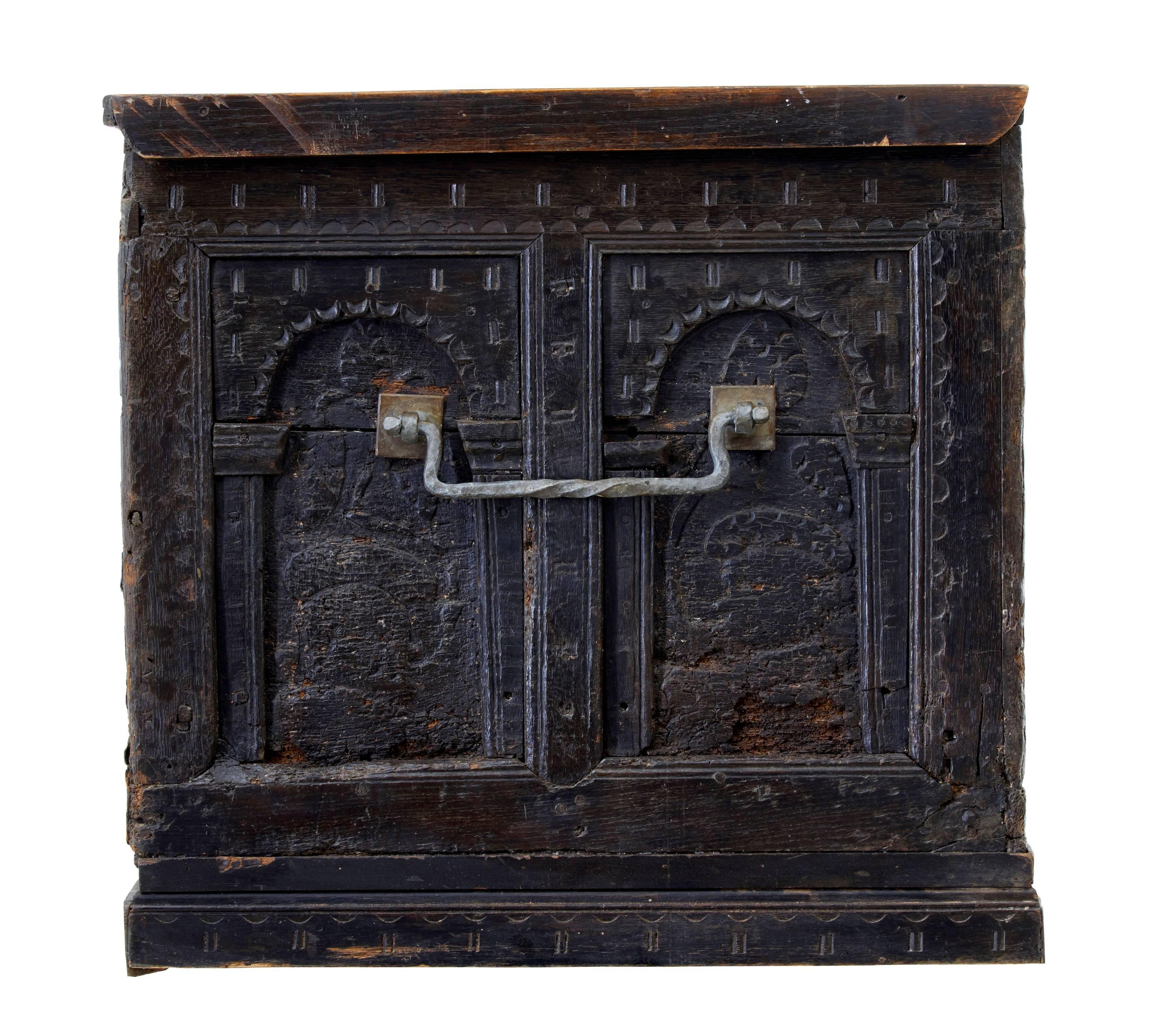 Large continental possibly Germanic carved oak coffer, circa 1640.
Four arcaded panels to the front. Two with carving and the central two with traces of original painted decoration of a family crest.
Later replaced lower edge sides. Later