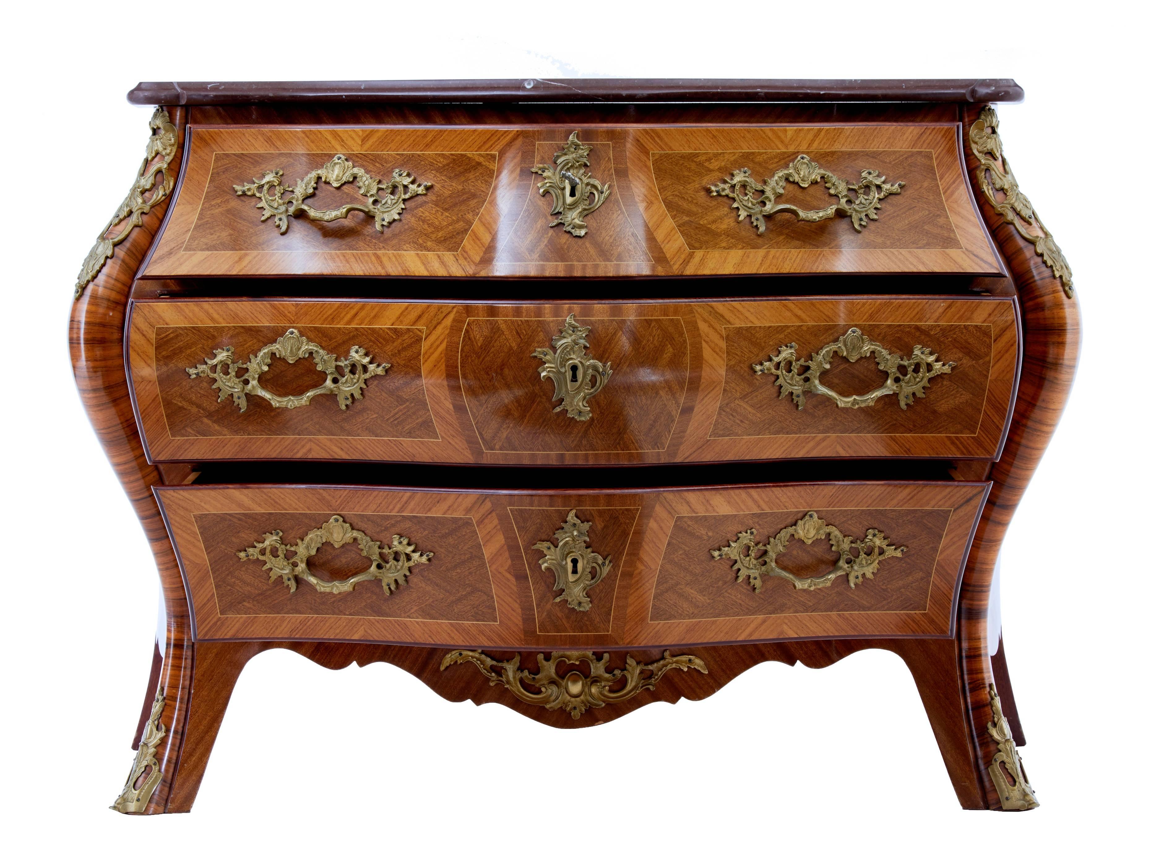 Excellent quality commode by A.B Rococo Mobler.
Beautifully bombe shaped marble top commode. Veneered using mahogany, walnut, satinwood and kingwood.
Decorated with rocaille and leaf shaped ormolu mounts.
Three drawers. Very elegant