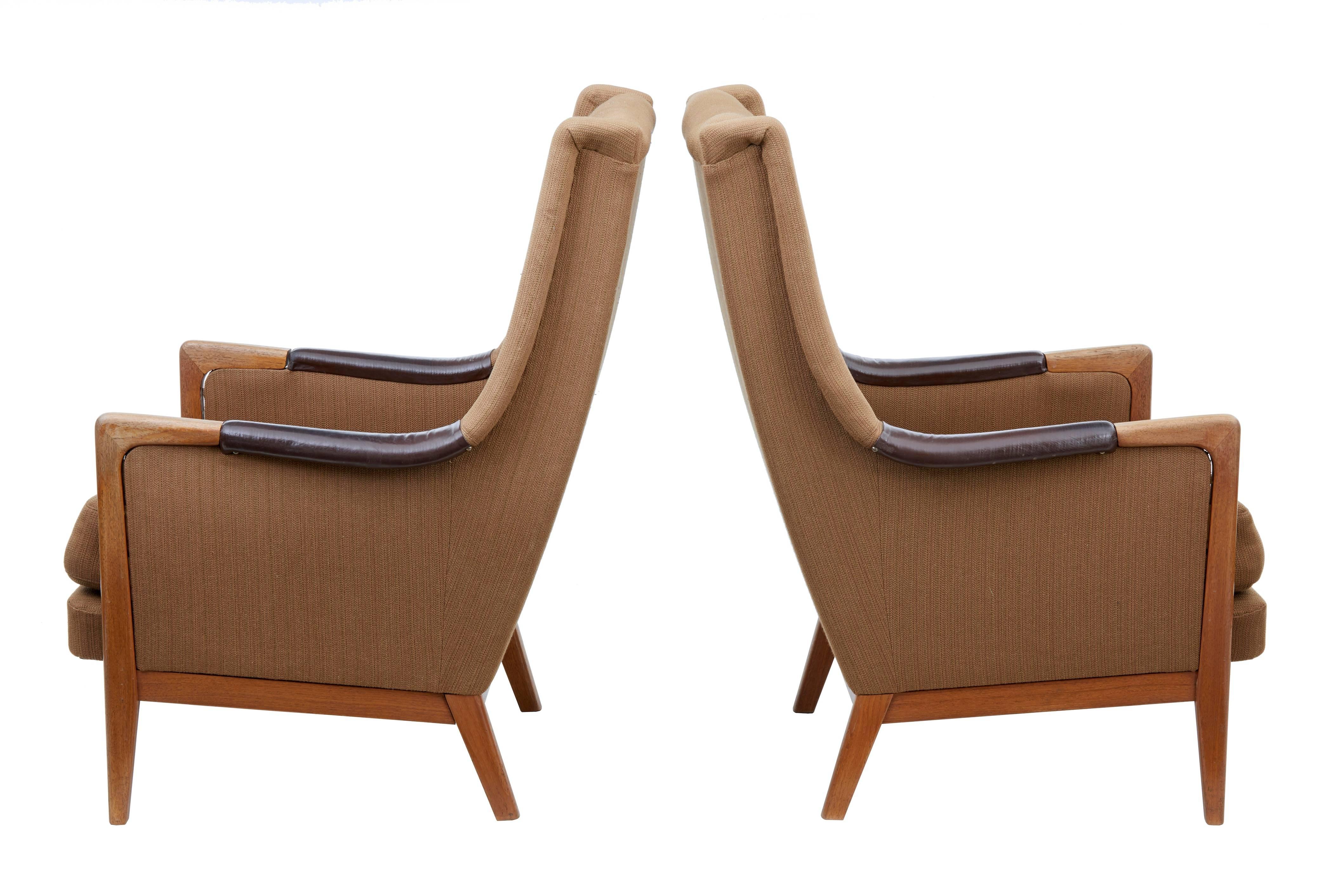 Pair of Danish teak modern armchairs, circa 1960.
Comfortable pair of modern armchairs. Button back seat and back.
Leather inserts to arms.
Teak show frame on the arm and legs.
Some fraying and pulls to fabric. Some fading to