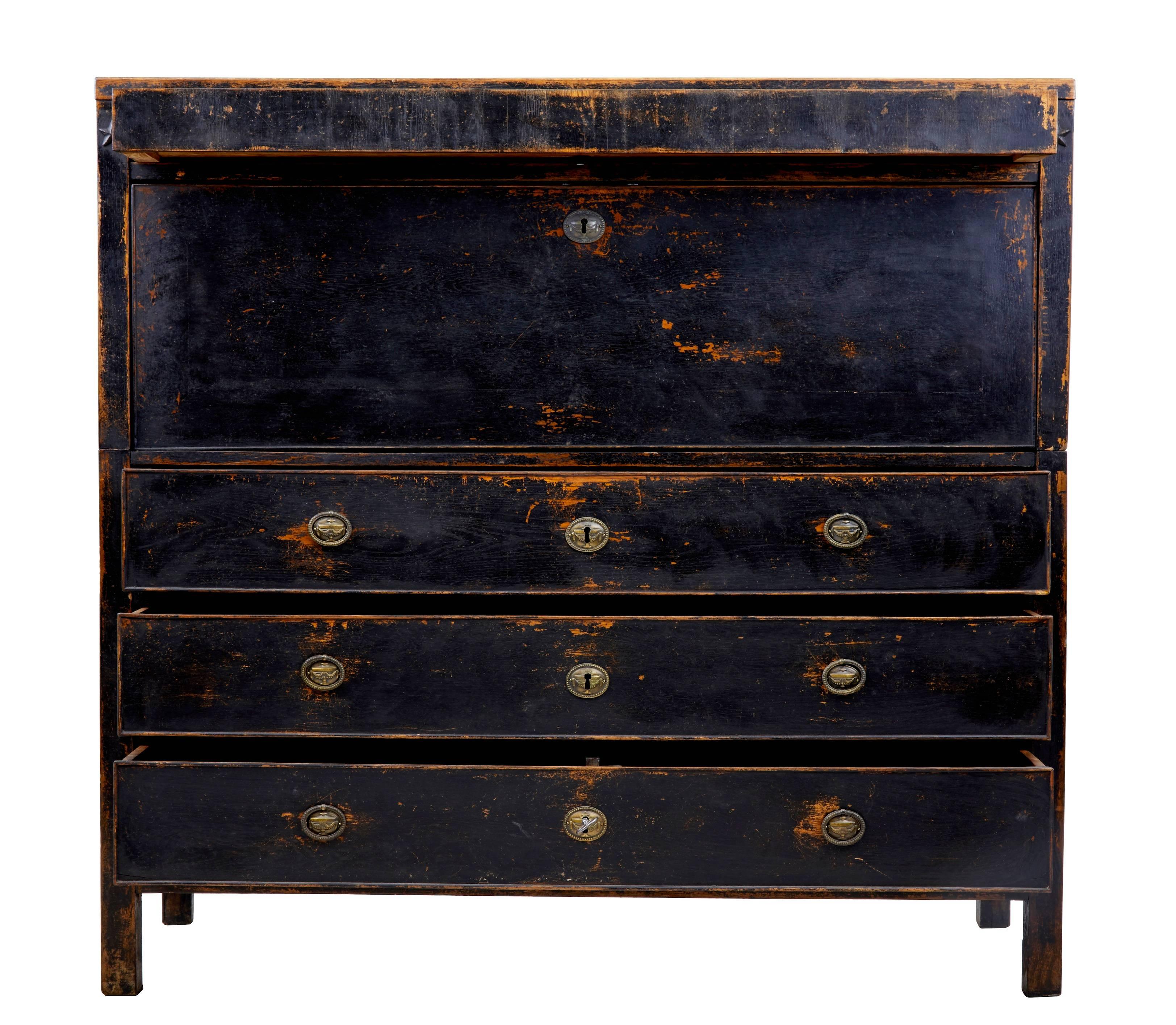 Oak escritoire of large proportions, circa 1860.
Two parts.
Later black paint has now weathered and worn giving its current appearance.
Fall drops down to reveal a fitted interior. Central lockable cupboard flanked either side by pigeon holes and