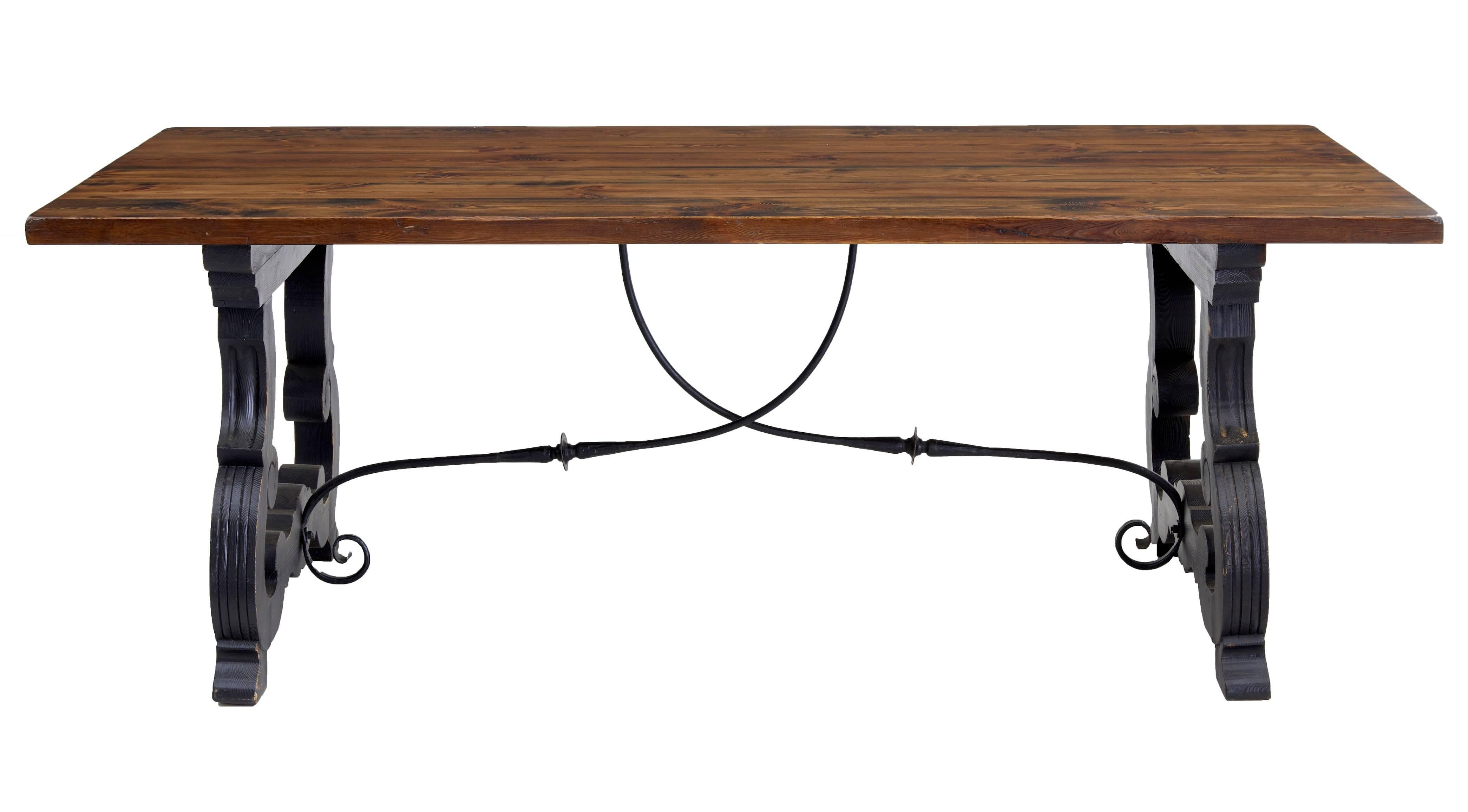 1960s refectory dining table made in the Spanish taste.
Pine stained top, which seats 8-10.
Typical Spanish style trestle legs which and supported by wrought iron crossover stretchers.
1 1/2 inch thick top.

Height: 29 1/2
