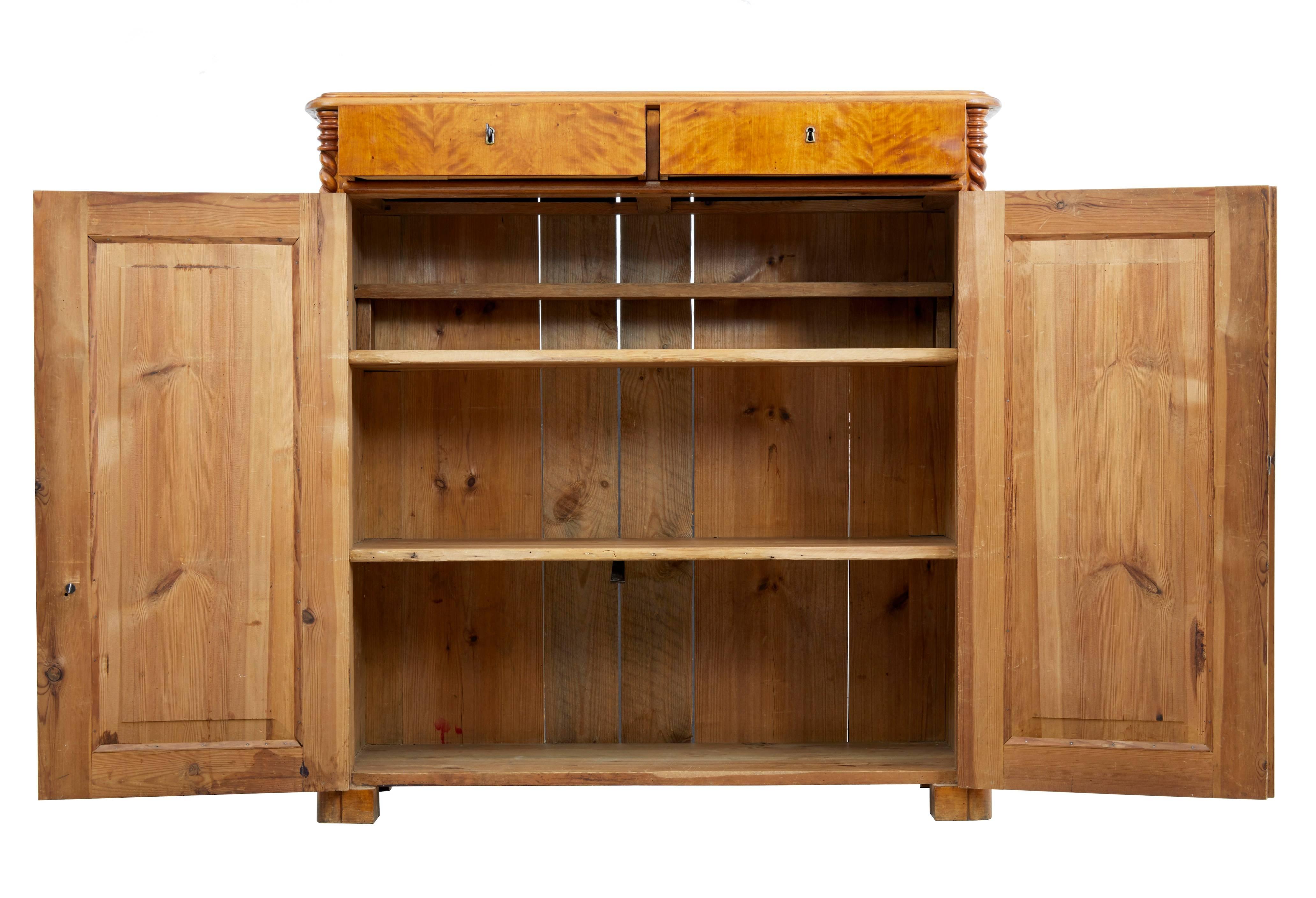 Swedish birch sideboard or cupboard, circa 1870.
Rich varnished birch color.
Two drawers with working locks and key. Double doors open to three shelves.
Main feature being the candy twist columns which run the height of the piece.
Standing on