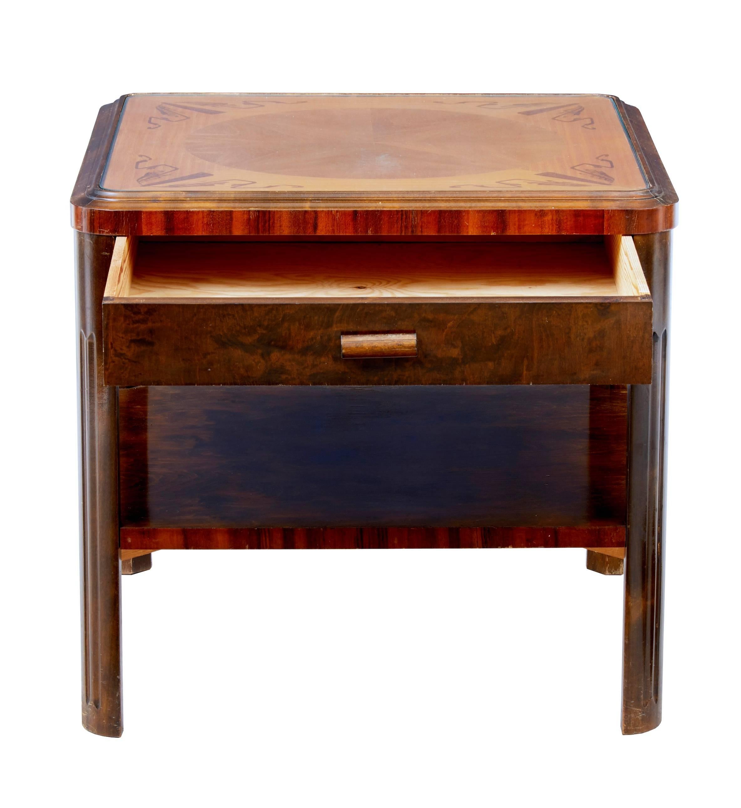 Good quality Swedish birch coffee table, circa late 1940s.
Inlaid and crossbanded with walnut, rosewood and further birch. Protected by a glass drop in top.
Single drawer to the front with shelf space below.
Minor marks to woodwork.

Height: 22