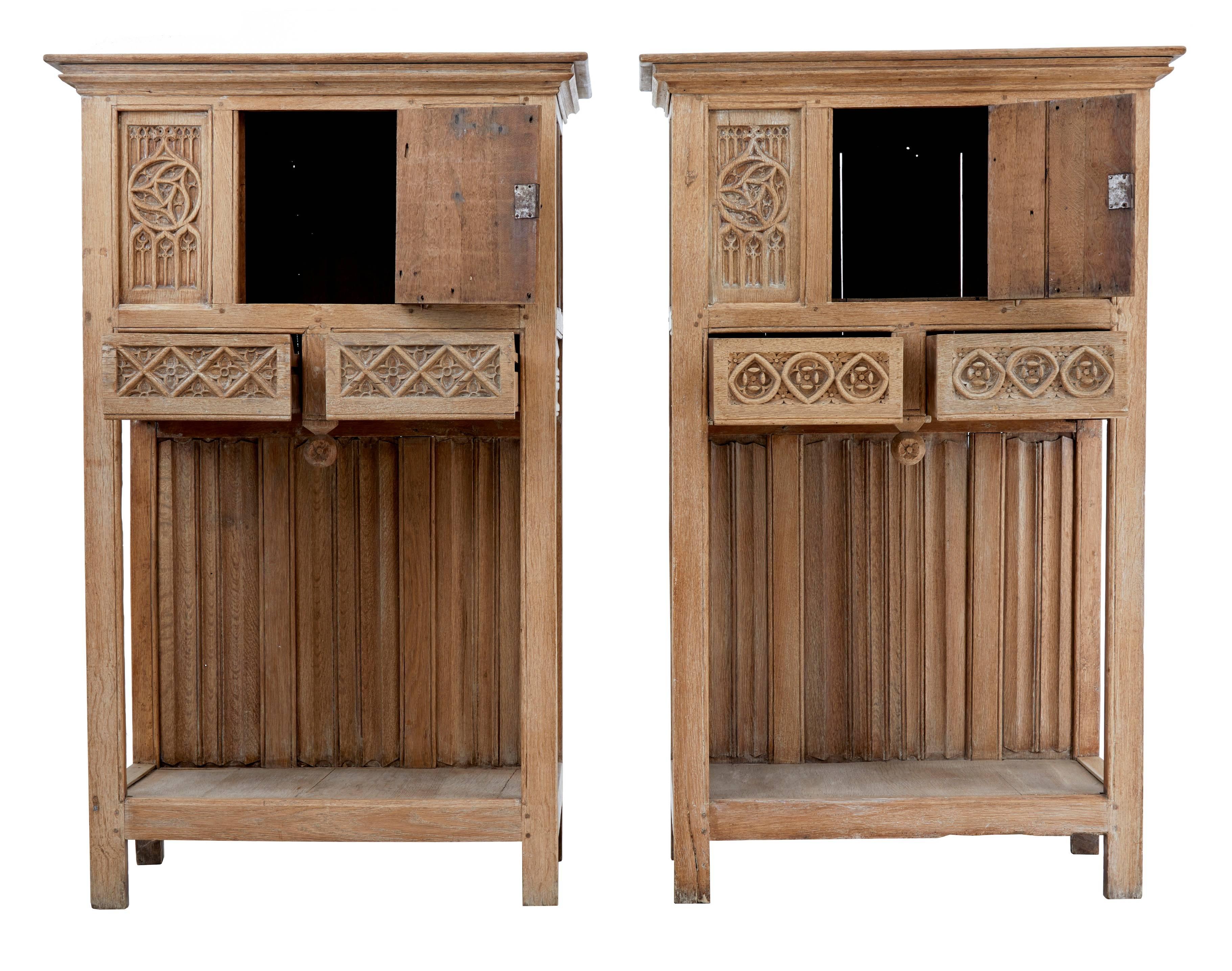 Rare pair of Victorian Gothic Revival cabinets, circa 1880.
Now stripped to a bare oak color.
Beautifully carved tracery panels. Single door opens for cupboard space, below which are two drawers.
Linen fold carved oak back panels provide the back