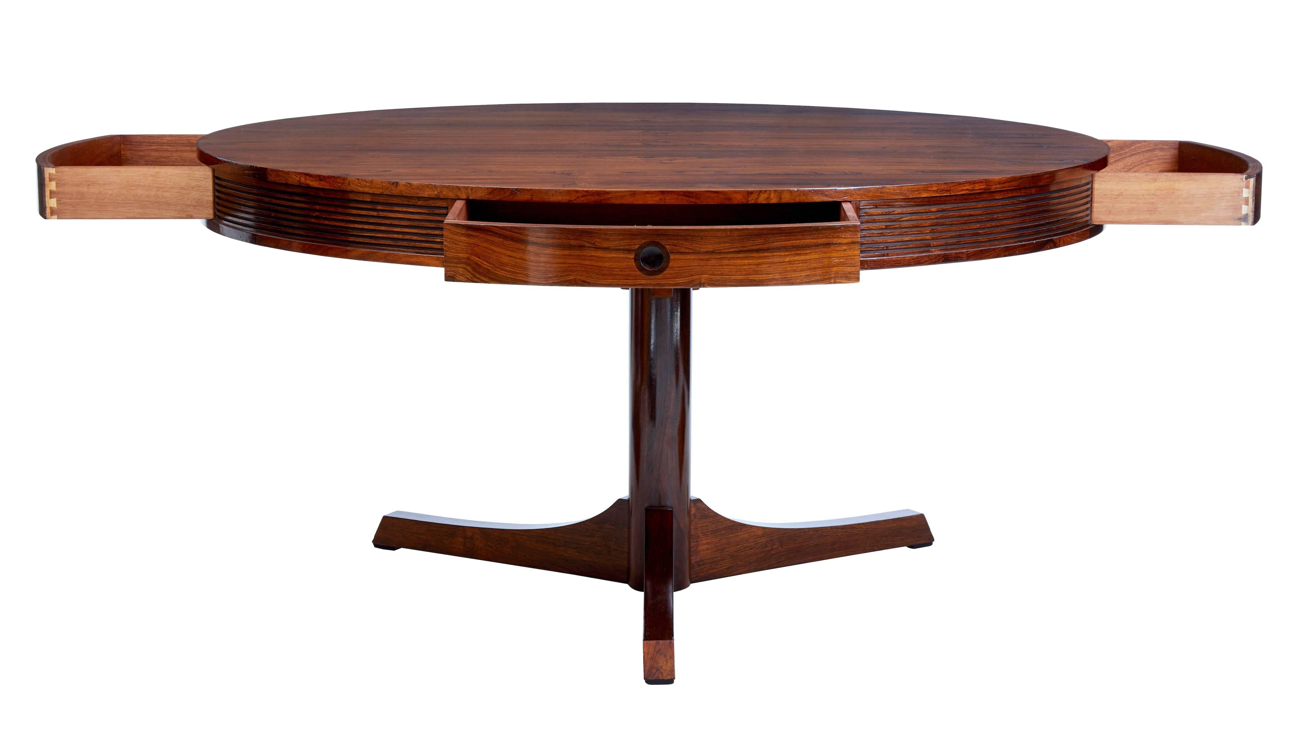 Fine quality mid-1960s drum table by Robert Heritage for Archie Shine.
Striking Rio rosewood matched veneer top.
Reeded frieze in between four drawers around the surface.
There are many possible uses for this table, such as a dining table or