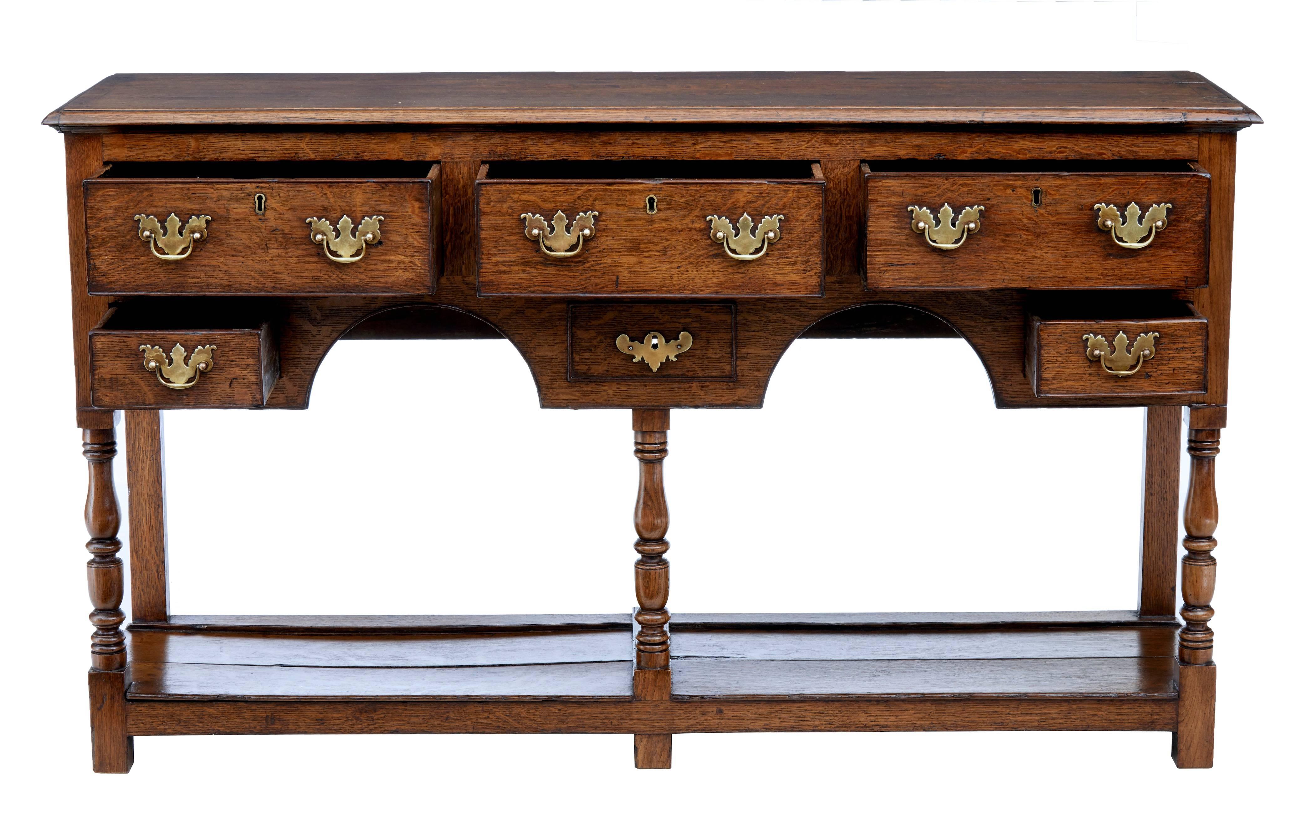 Very pretty 18th century oak dresser base, circa 1770.
Of good color and desirable narrow proportions.
Three drawers below the top surface with further spice drawers and one dummy drawer below.
Pot board storage and display surface.
Standing on