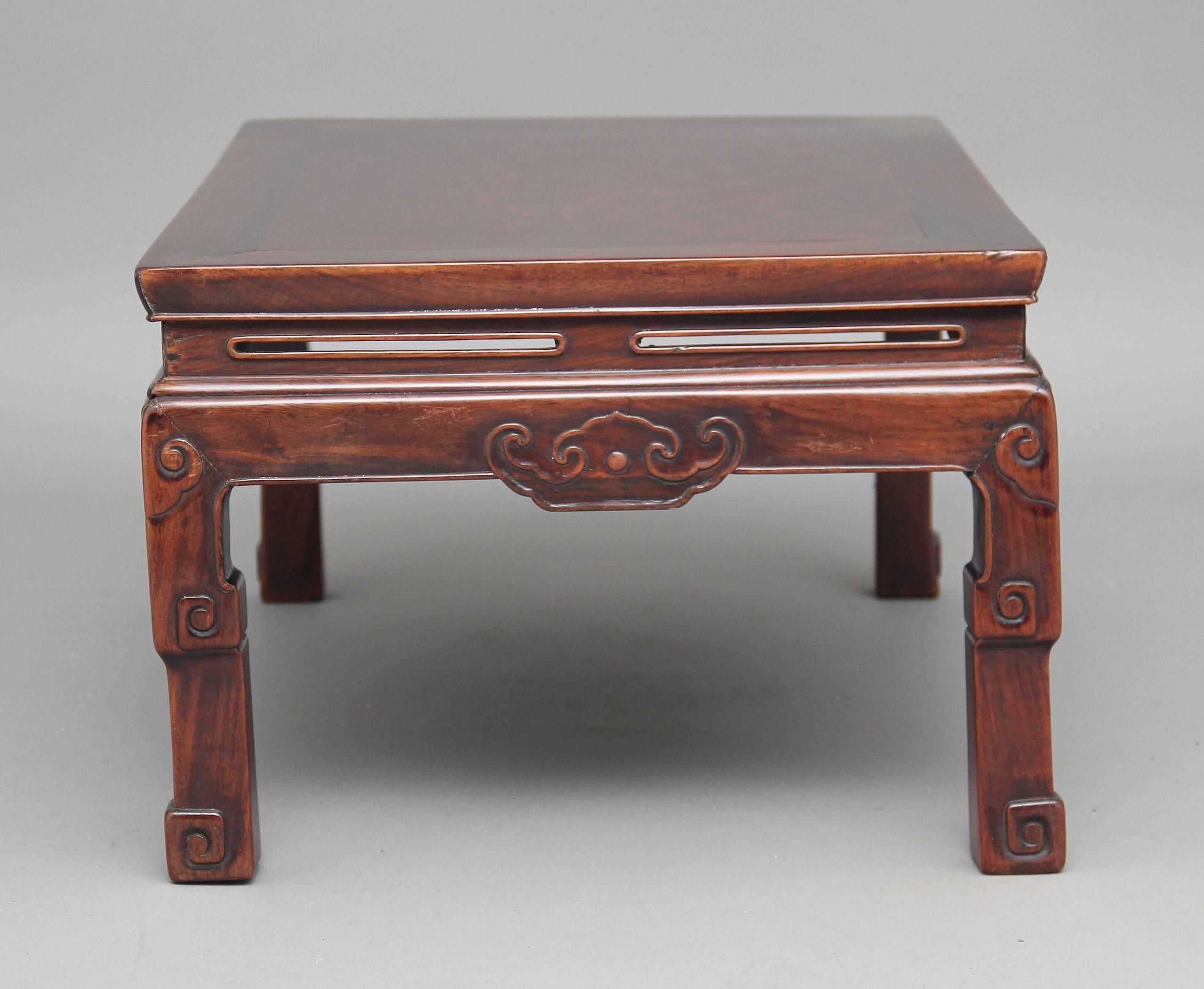 19th century rosewood Chinese coffee table, the rectangular top with pierced decoration around the sides and front having a carved pattern below, supported on square legs ending on carved and scroll feet, circa 1880.

Height: 13