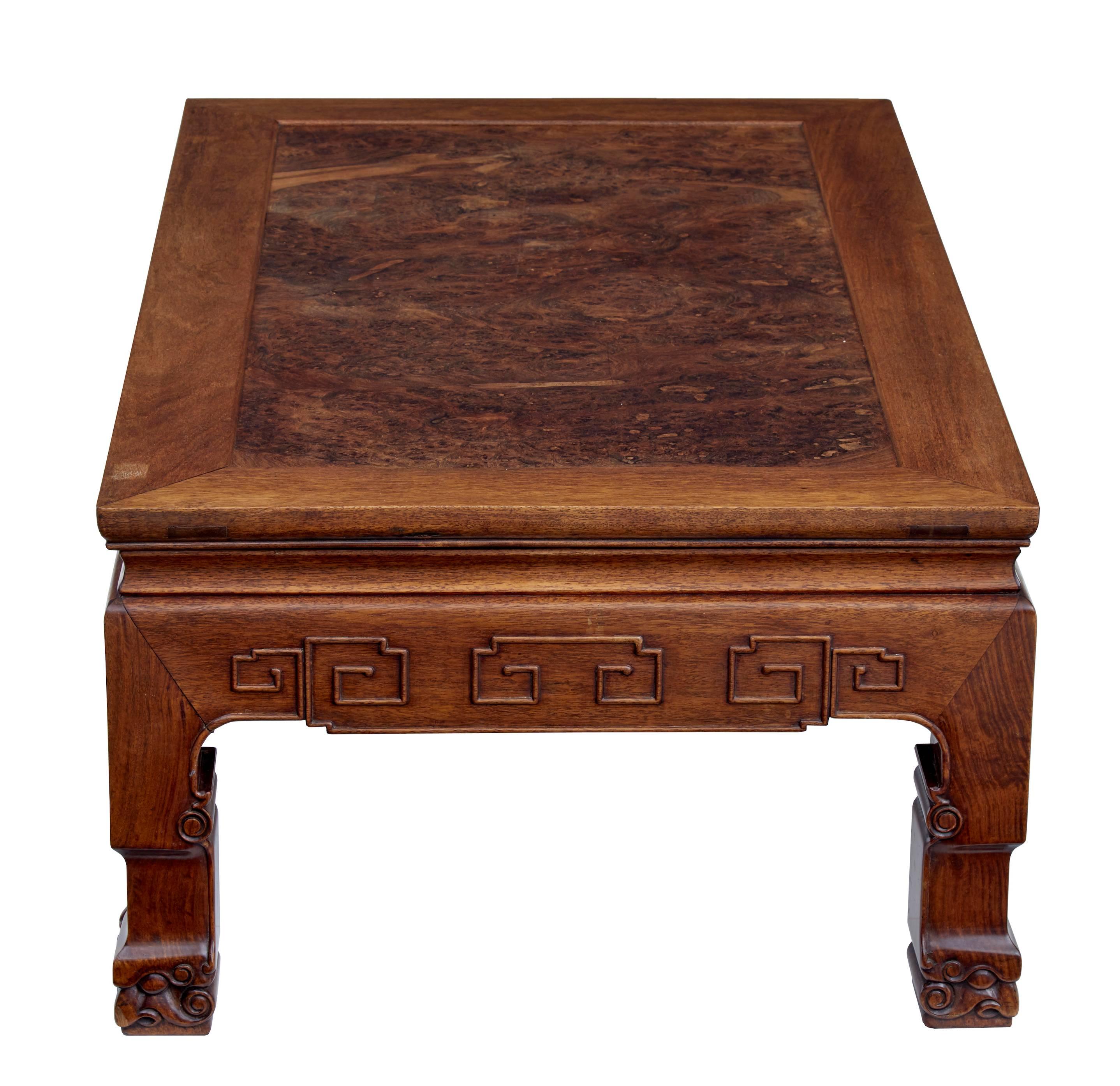 Good quality heavy low kang table, circa 1900. Made from Huanghuali with burr wood insert. Carved decoration to sides. Standing on four carved scrolling feet. Measures: Height 16