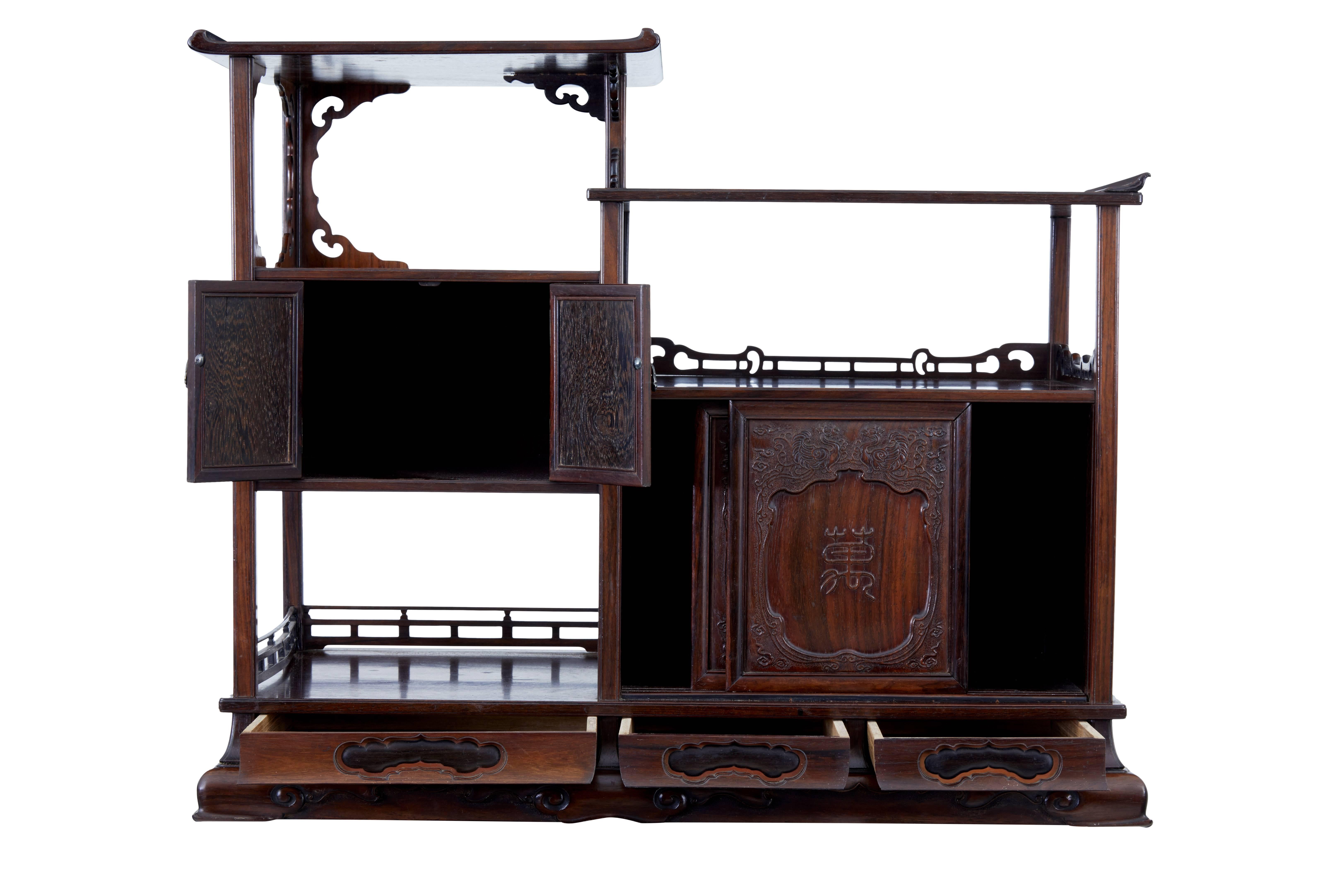Chinese curio cabinet created from very fine Huanghuali wood, the hinged doors made from jichimu framed in huanghuali and the central flower heads on each door crafted from precious zitan surrounded by a box wood border, the handles made from silver