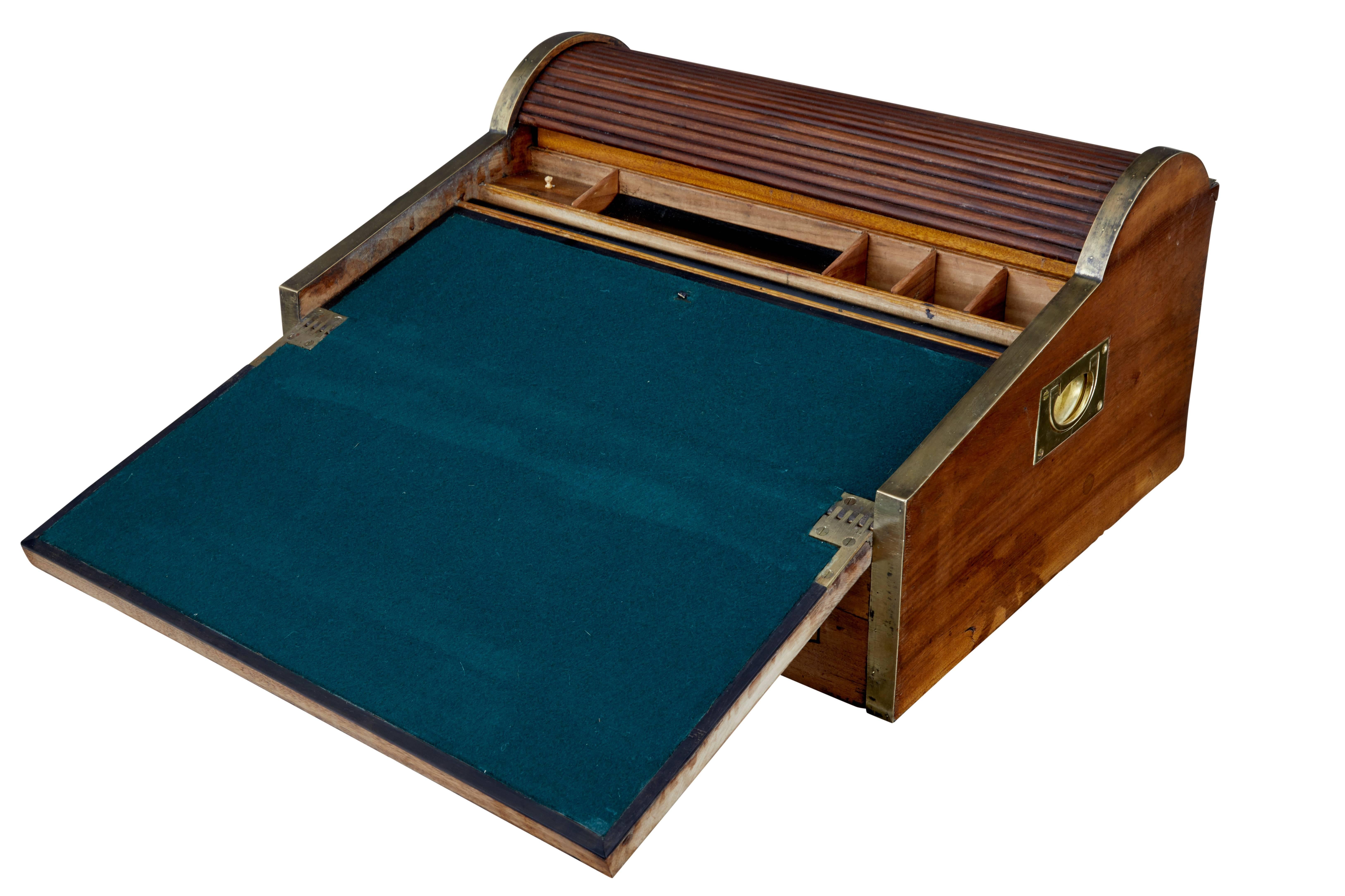 Quality Chinese export camphor wood lap desk, circa 1820. Made for sea Captains and military officers in the field. Brass bound round the outer edge with brass carrying handles. Tambour top opens when you open the front drawer to reveal storage in