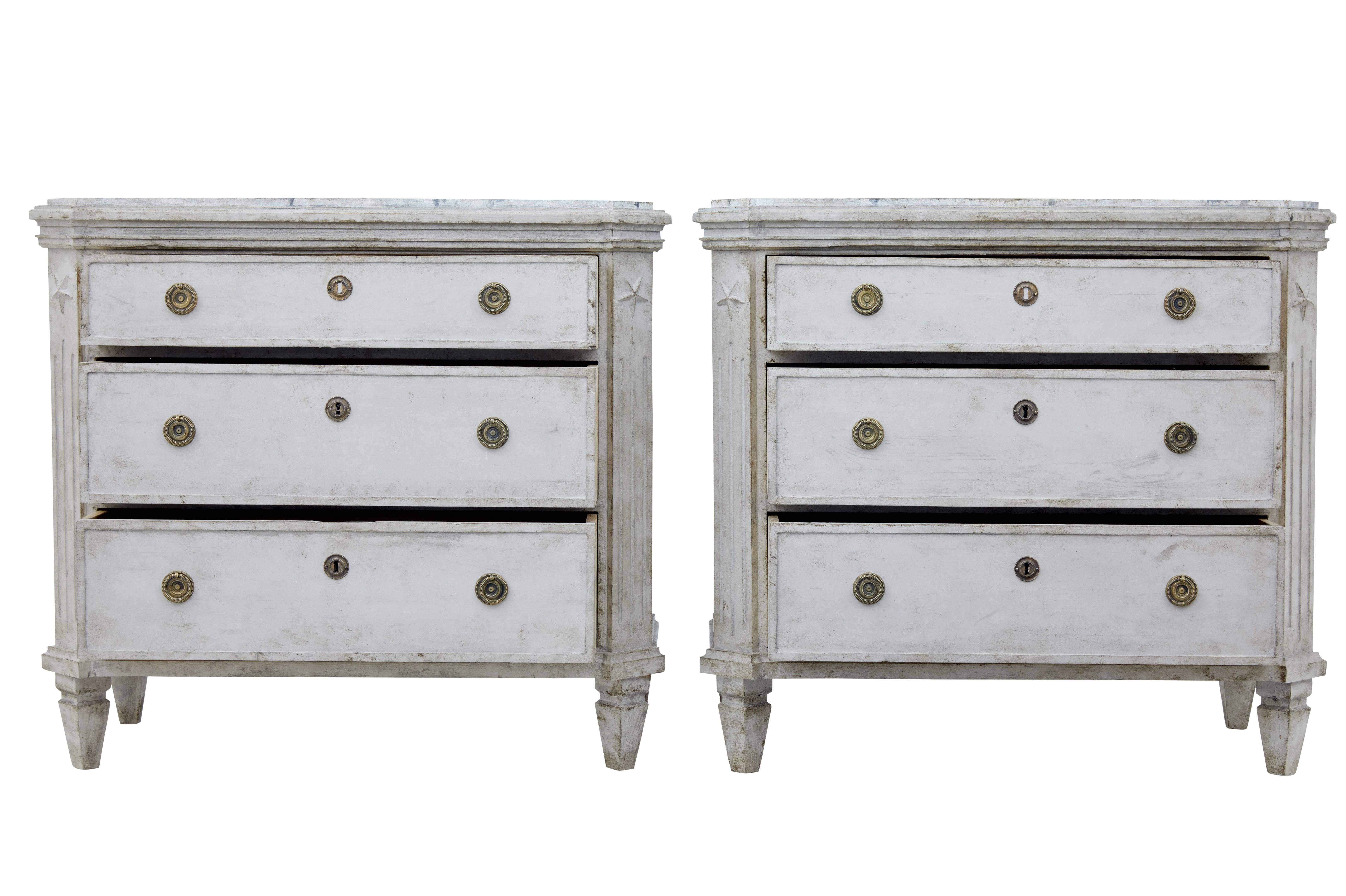 Elegant pair of Swedish painted commodes, circa 1880.

Three graduating drawers, canted corners, standing on four tapering feet.
Later weathered paint with faux marble painted tops.

Height: 30 3/4