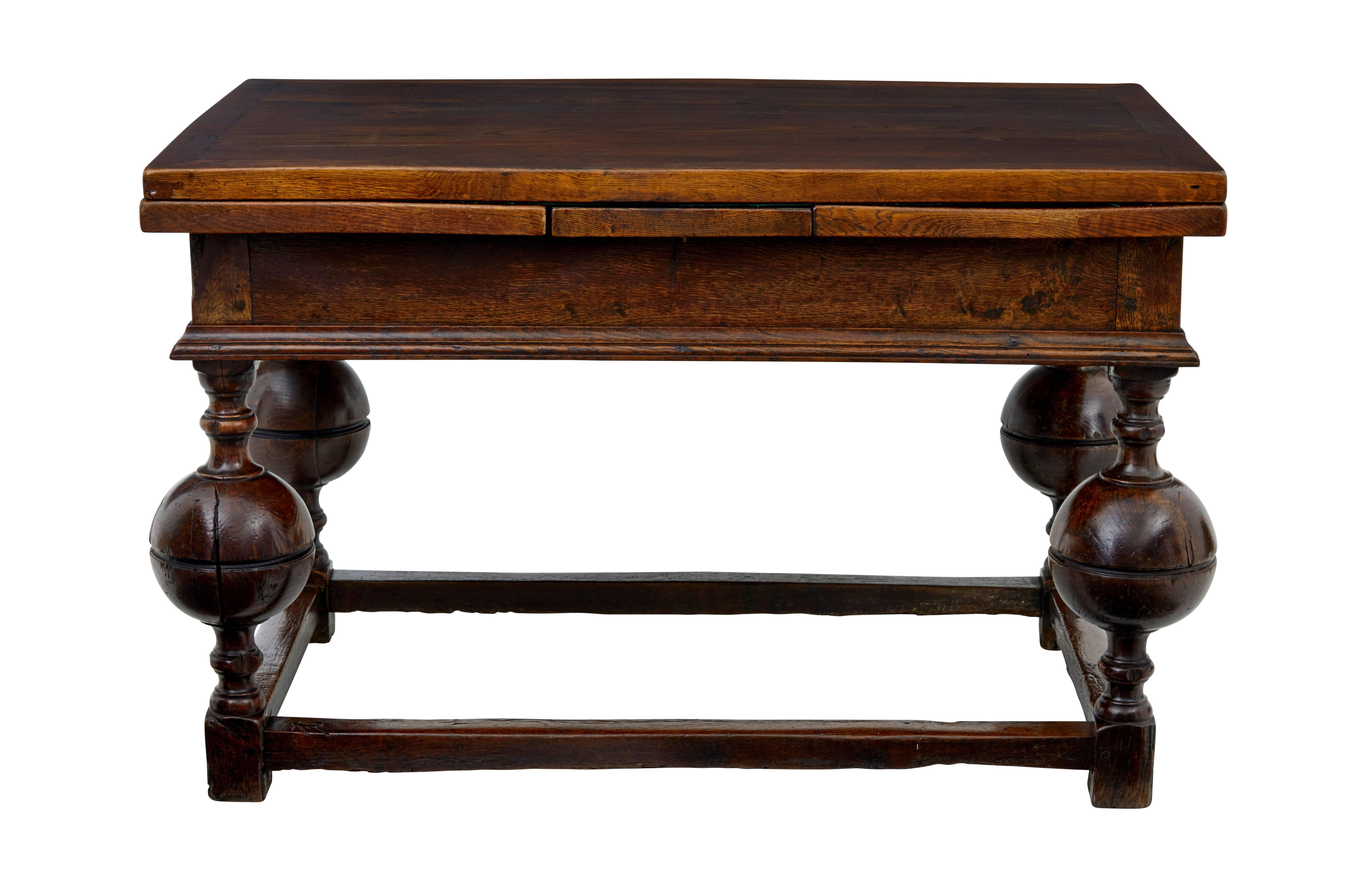 Beautiful early 19th century kitchen dining table, circa 1800.

Seats six and with the leaves pulled out there is room for a further four.
All solid oak and quite a heavy item.
Stands on four baluster sphere turned legs, united by