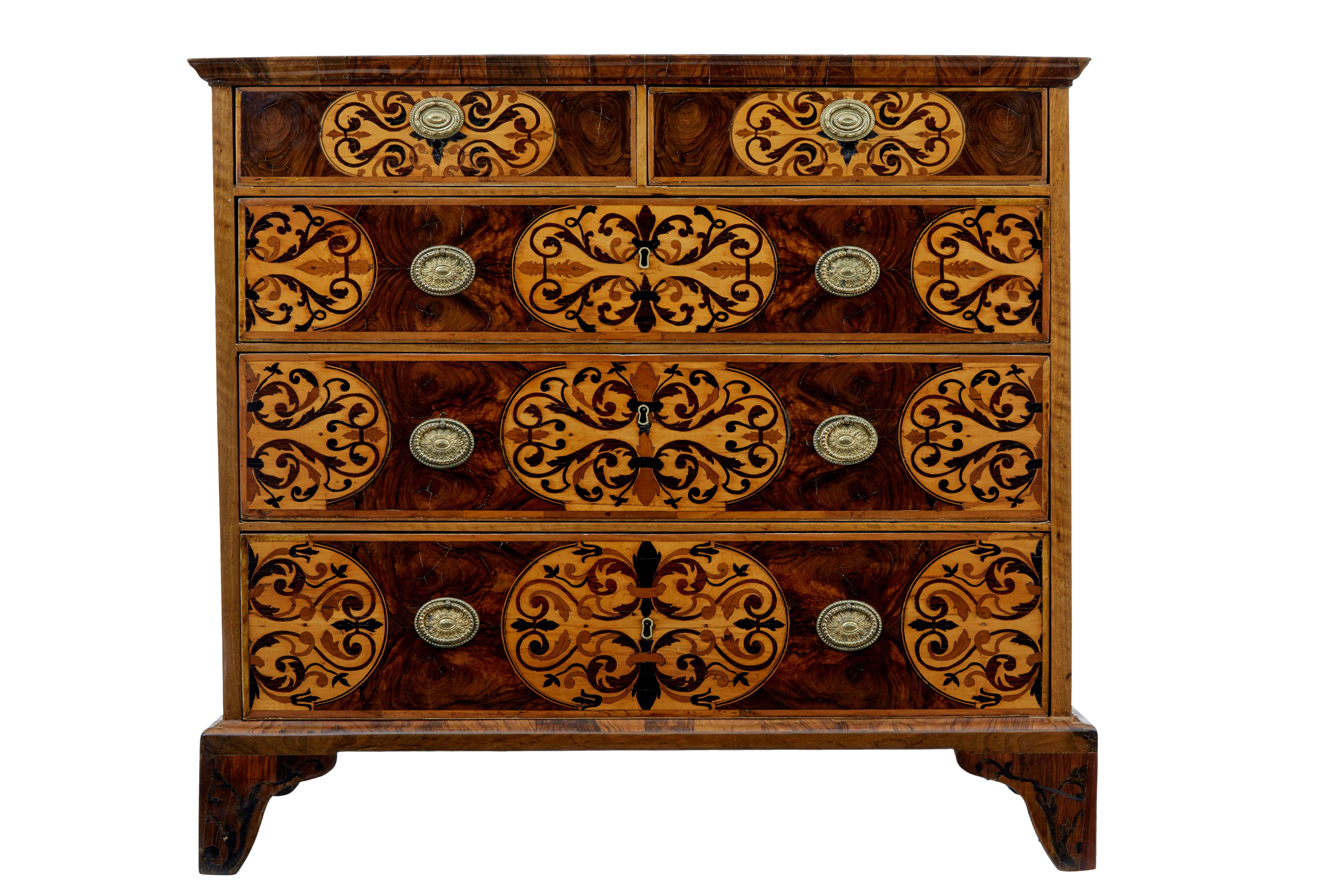 Beautiful two over three chest of drawers, circa 1710.
Five graduating drawers, inlaid with florals and swags and walnut oyster veneers.
Top surface with further inlay in ebony and boxwood.
Standing on bracket feet.
Later replacements