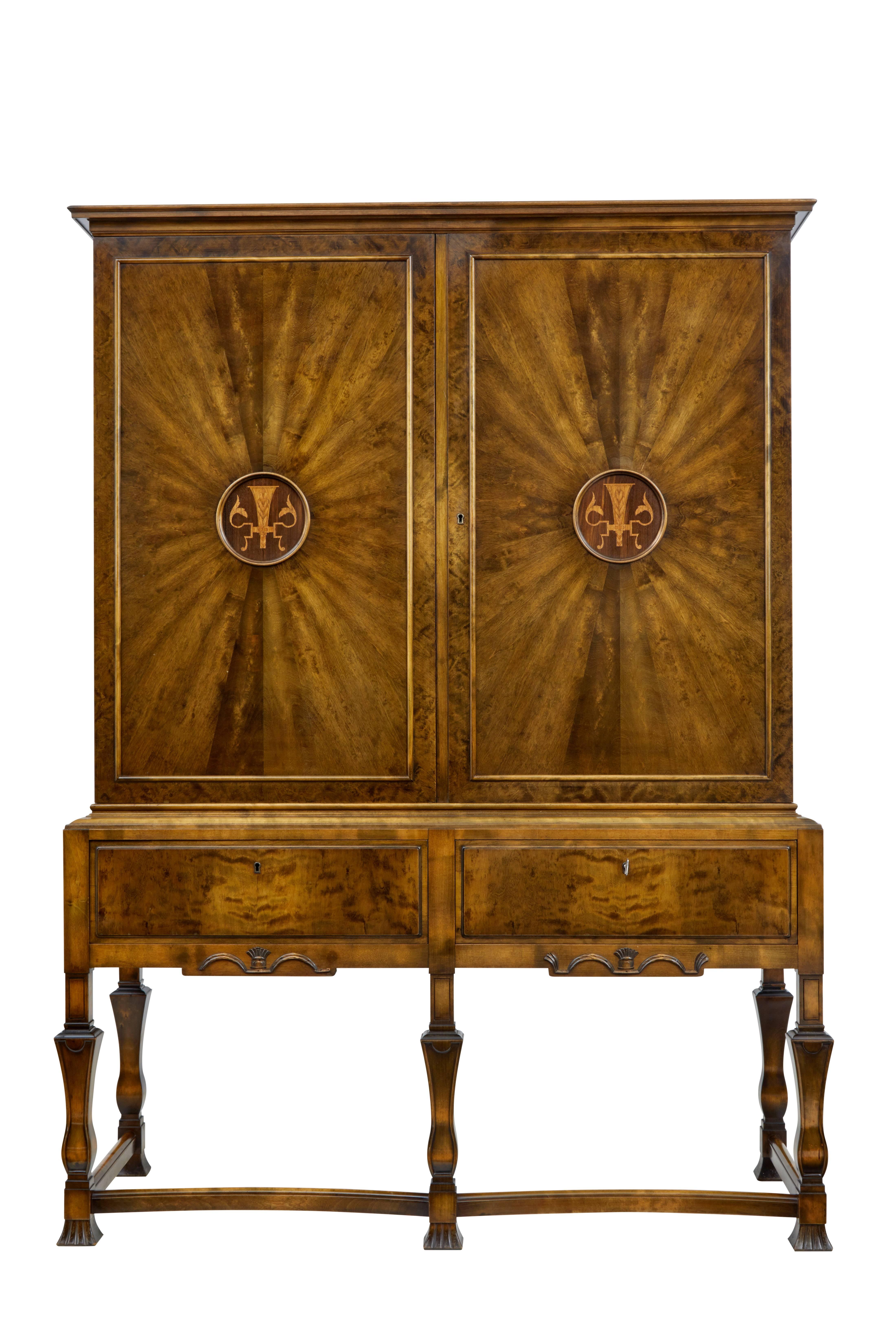 Here we can offer you a stunning one piece pure Art Deco cabinet, circa 1920.
Made from beautiful burr birch.
Segmented patterned door fronts, with inlaid central detailing.
Double doors open to a contrasting light birch interior with three