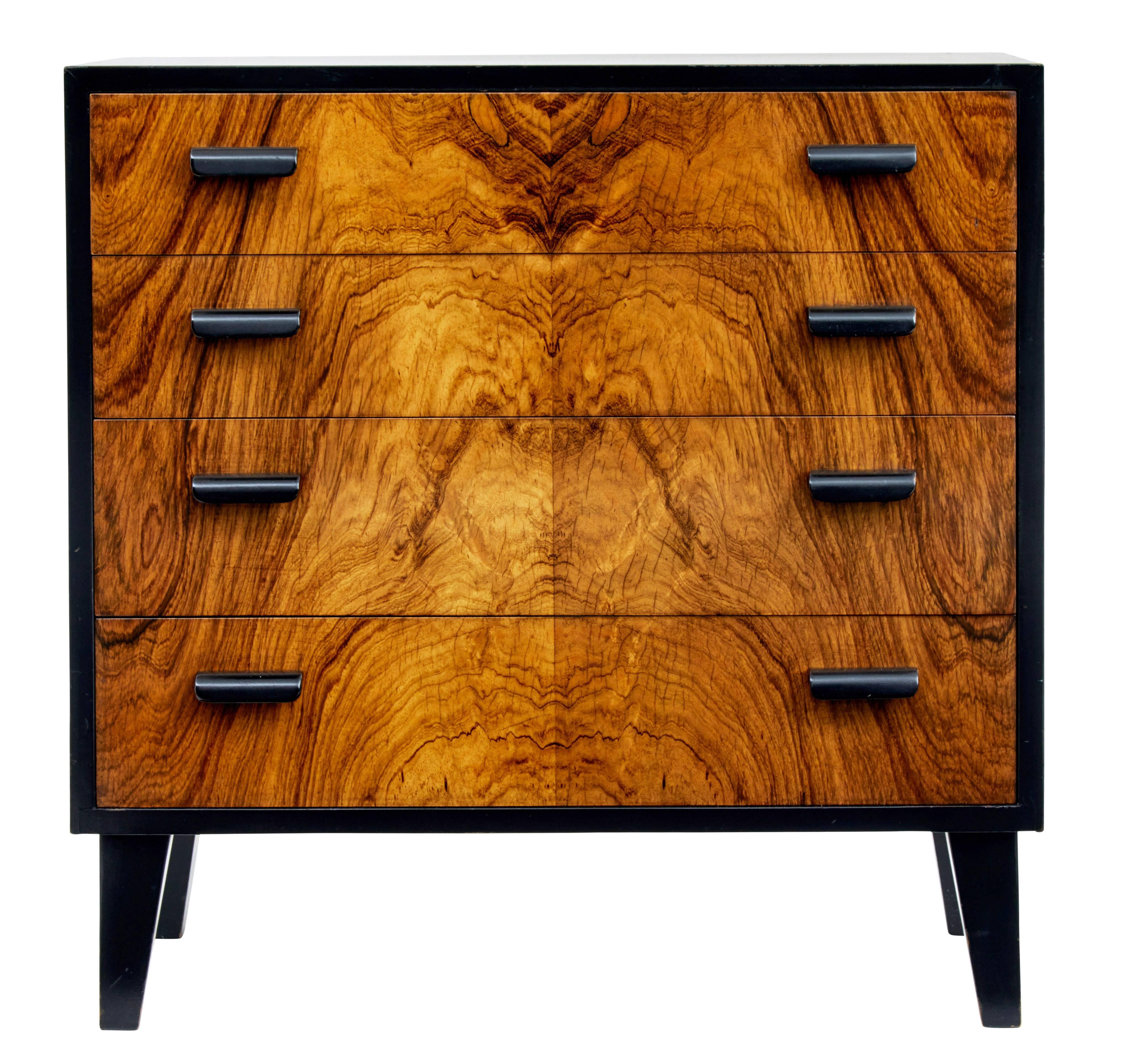 Stunning chest of drawers of small proportions, circa 1950.
Made in striking rosewood veneers.
Four drawers with ebonized handles.

Measures: Height 23 1/2