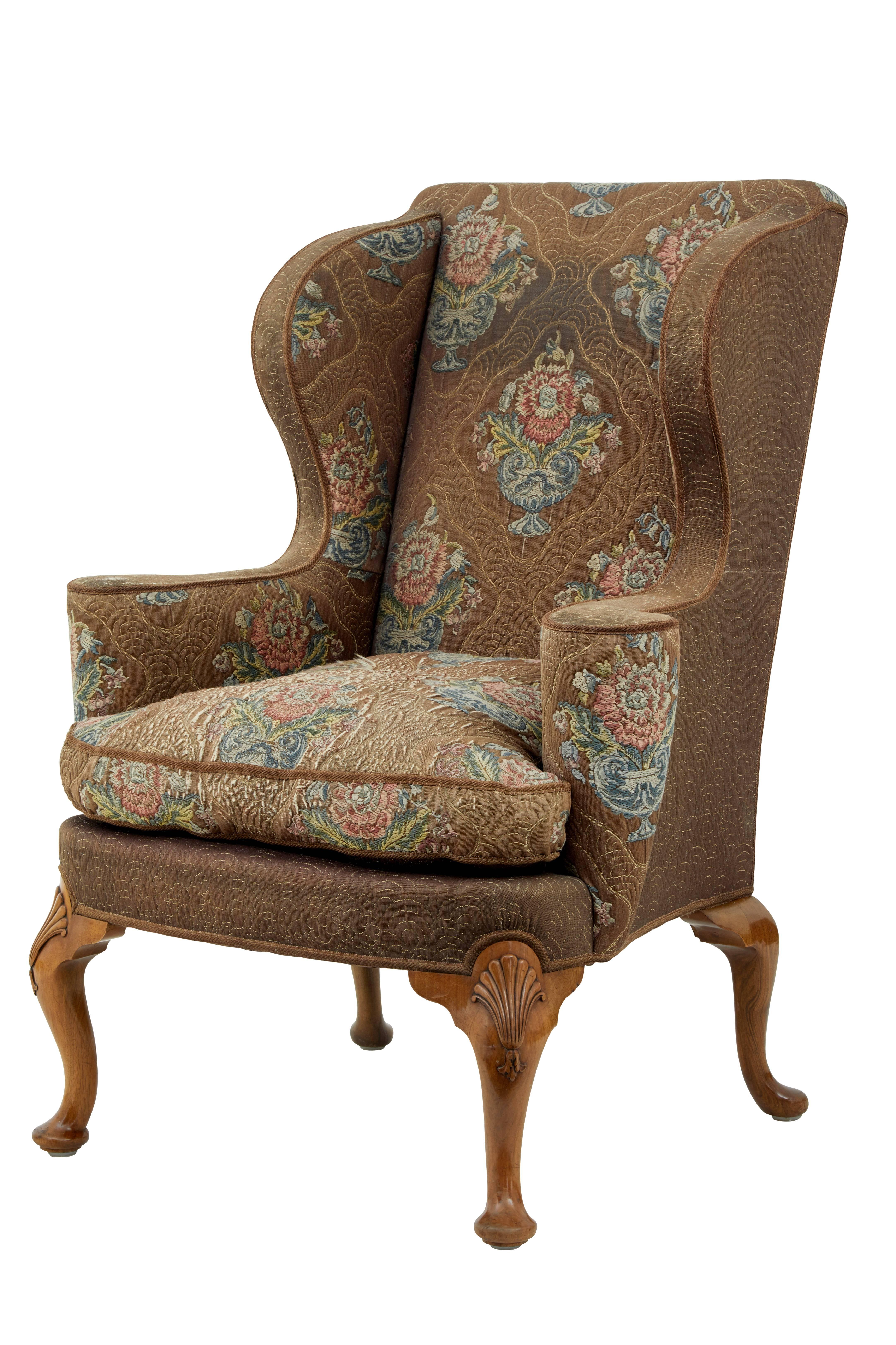 Stylish wing back armchair, circa 1900.
Very comfortable chair with original fabric.
Standing on four walnut cabriole legs with shells on the front knees.

Measures: Height: 44 1/2