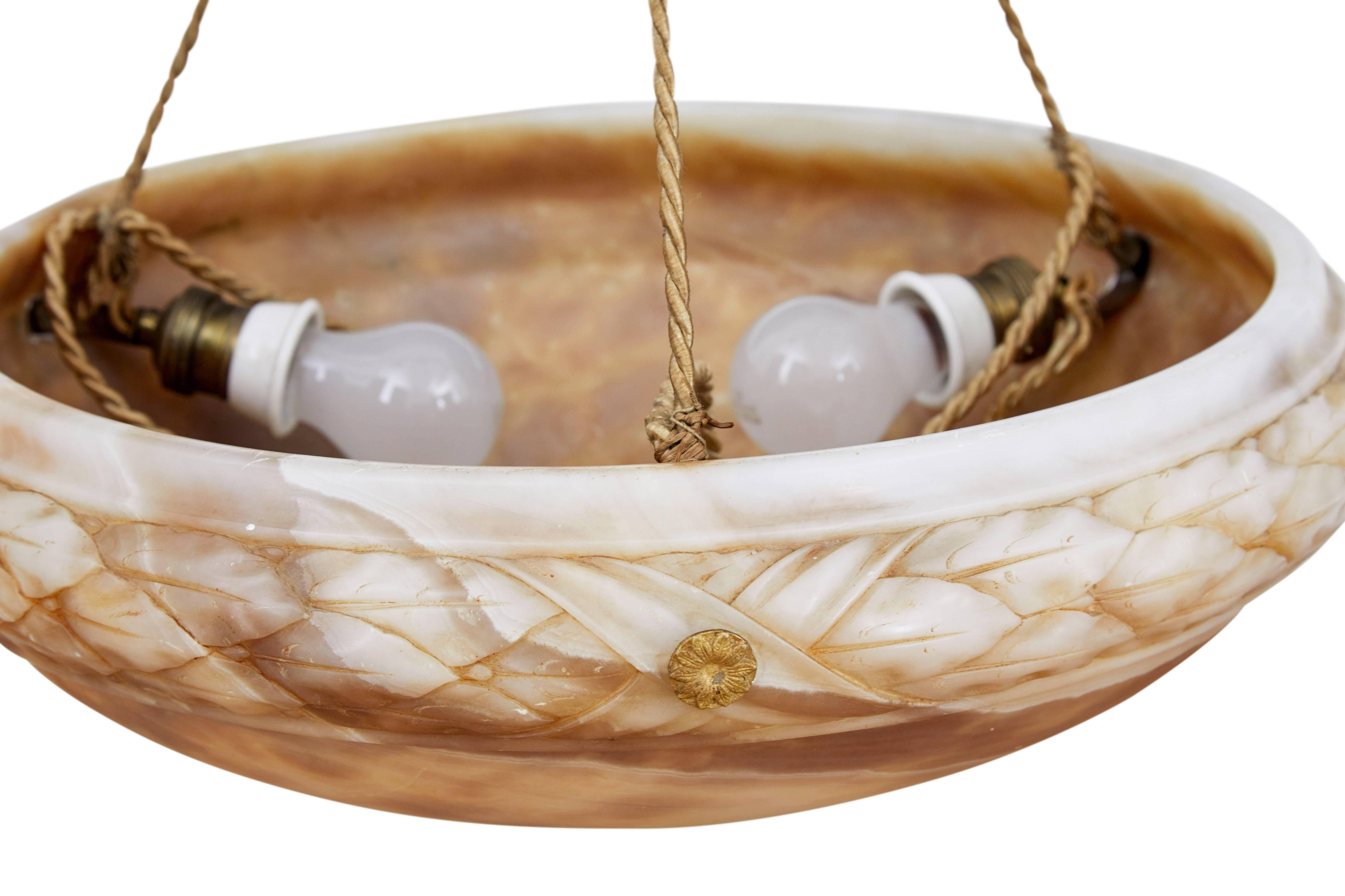 Good quality alabaster ceiling light, circa 1920.
Circular dish with carved detail around the edge.
Three bulb holders, suspended by three rope chains to central rose.

We recommend that this light is professionally rewired and