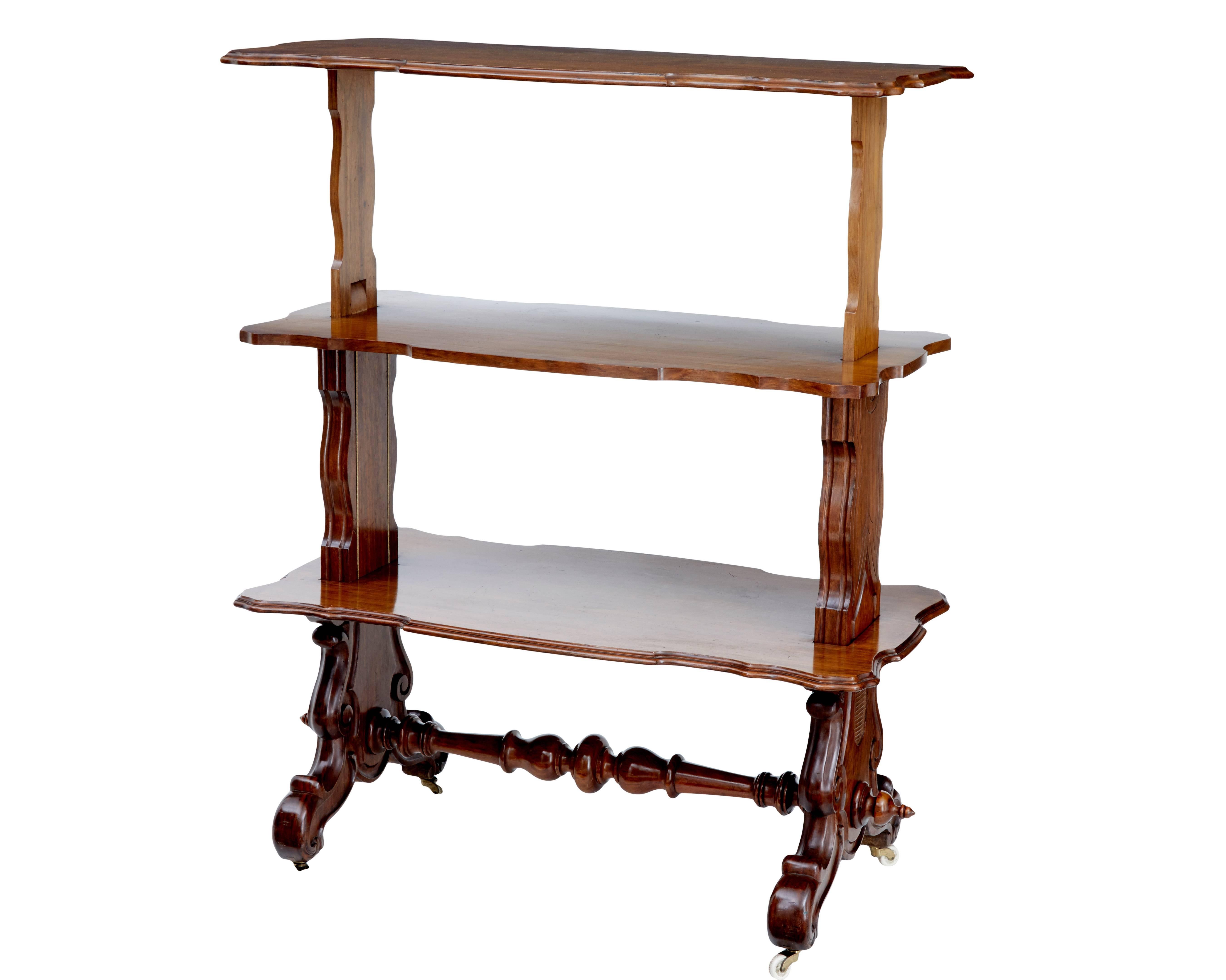 Practical piece of Victorian furniture, circa 1880.
Fine quality walnut dumb waiter that rises to form three tiers.
Legs united by turned stretcher, standing on ceramic castors.
     
