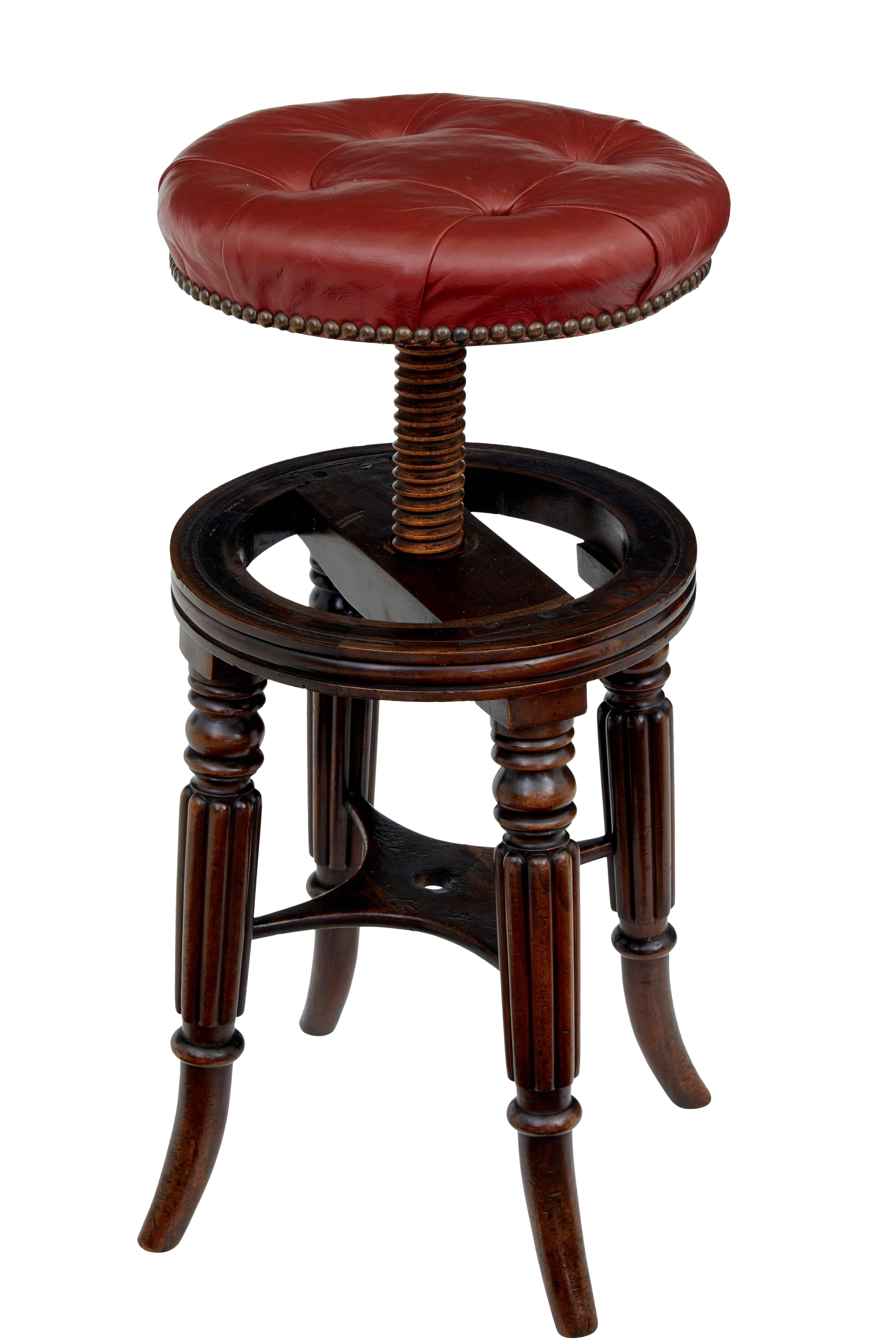 Victorian mahogany adjustable piano stool, circa 1890.

Buttoned red leather seat which rises by turning, seat height at lowest level is 19