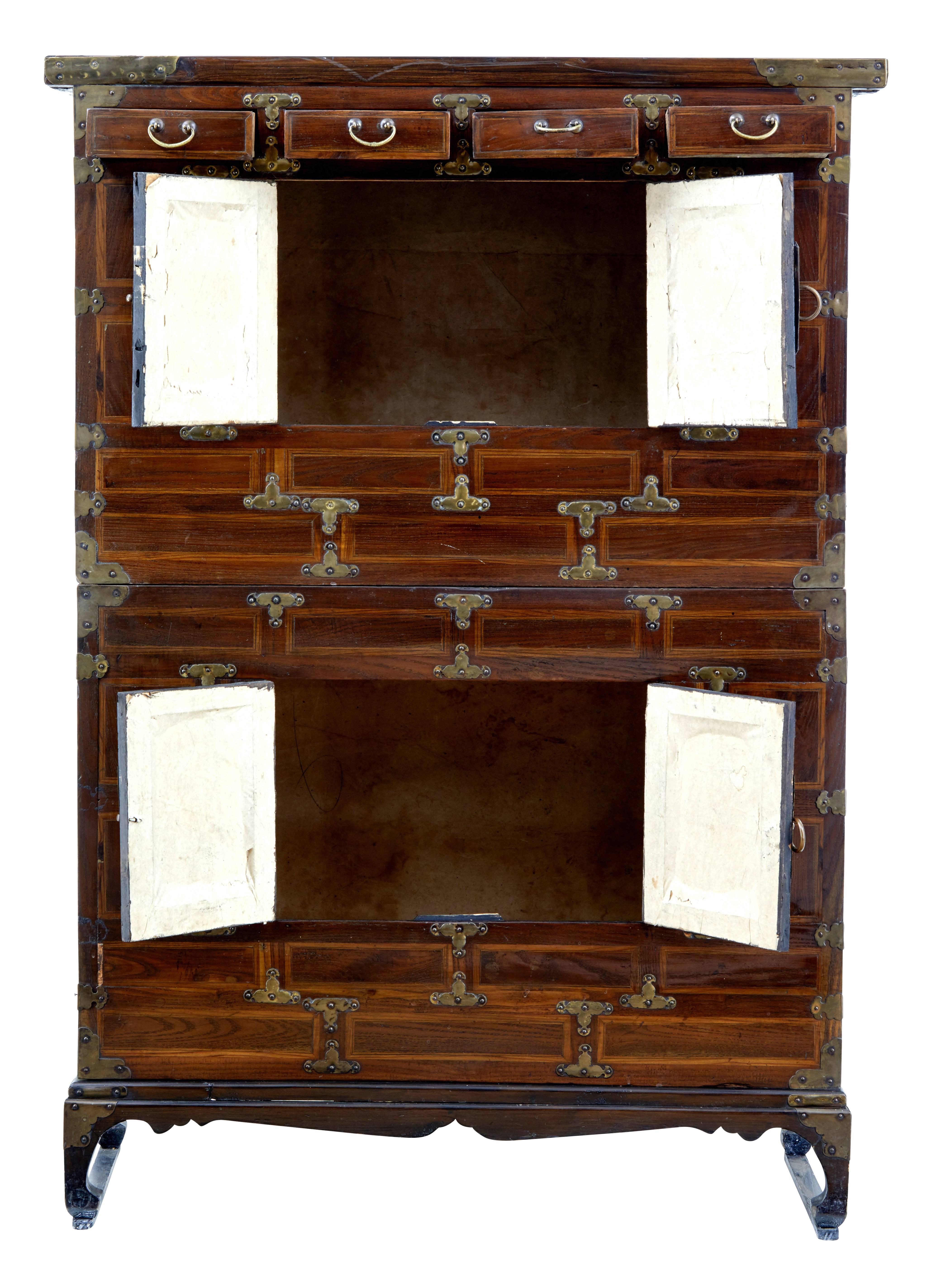 Decorative Chinese cabinet inlaid and made from softwood, circa 1890.

Comprising of two parts. Top section with four drawers to the top and a double door cabinet, bottom section with a double door cabinet.

Decorated with brass elements, hinges