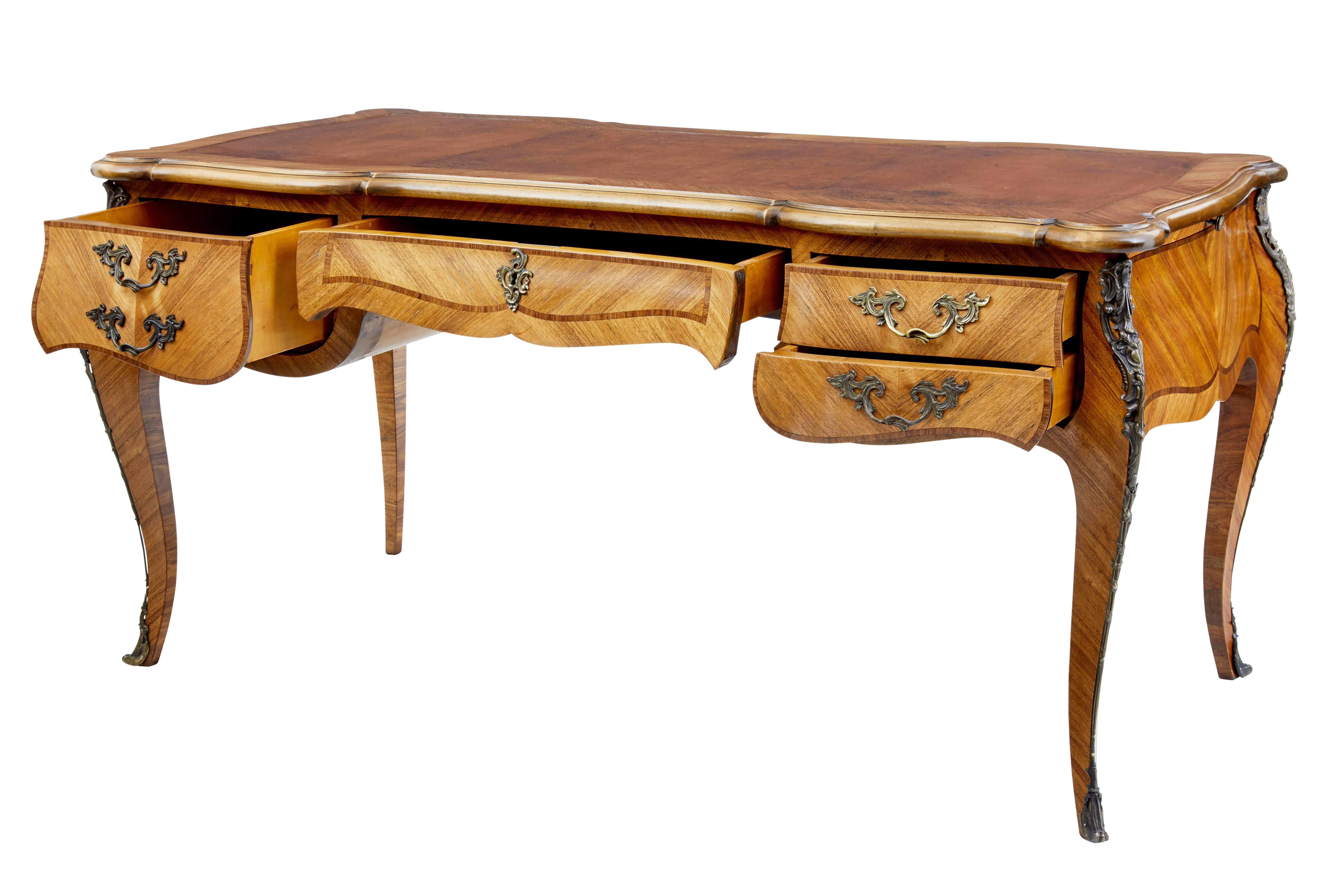 Here we offer a beautiful French bureau plat writing desk, circa 1890.

Original leather writing surface with tooling, shaped writing surface. Single drawer above the knee hole with a single deep drawer to the left and two drawers to the right.