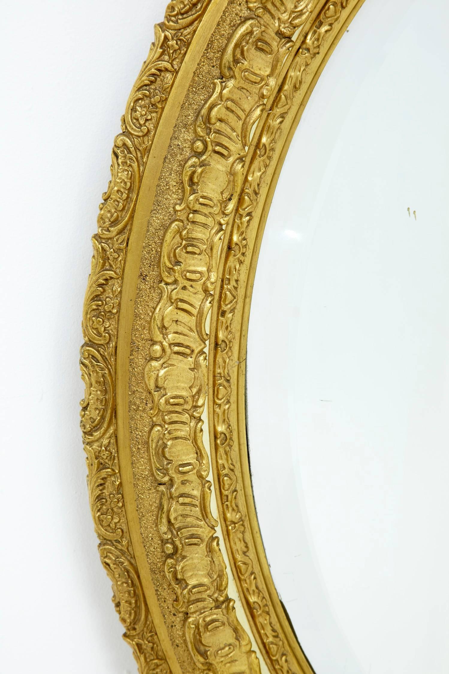 Beautiful carved ornate oval mirror, bevelled edge, circa 1870.
Some repairs and restoration to gilding.