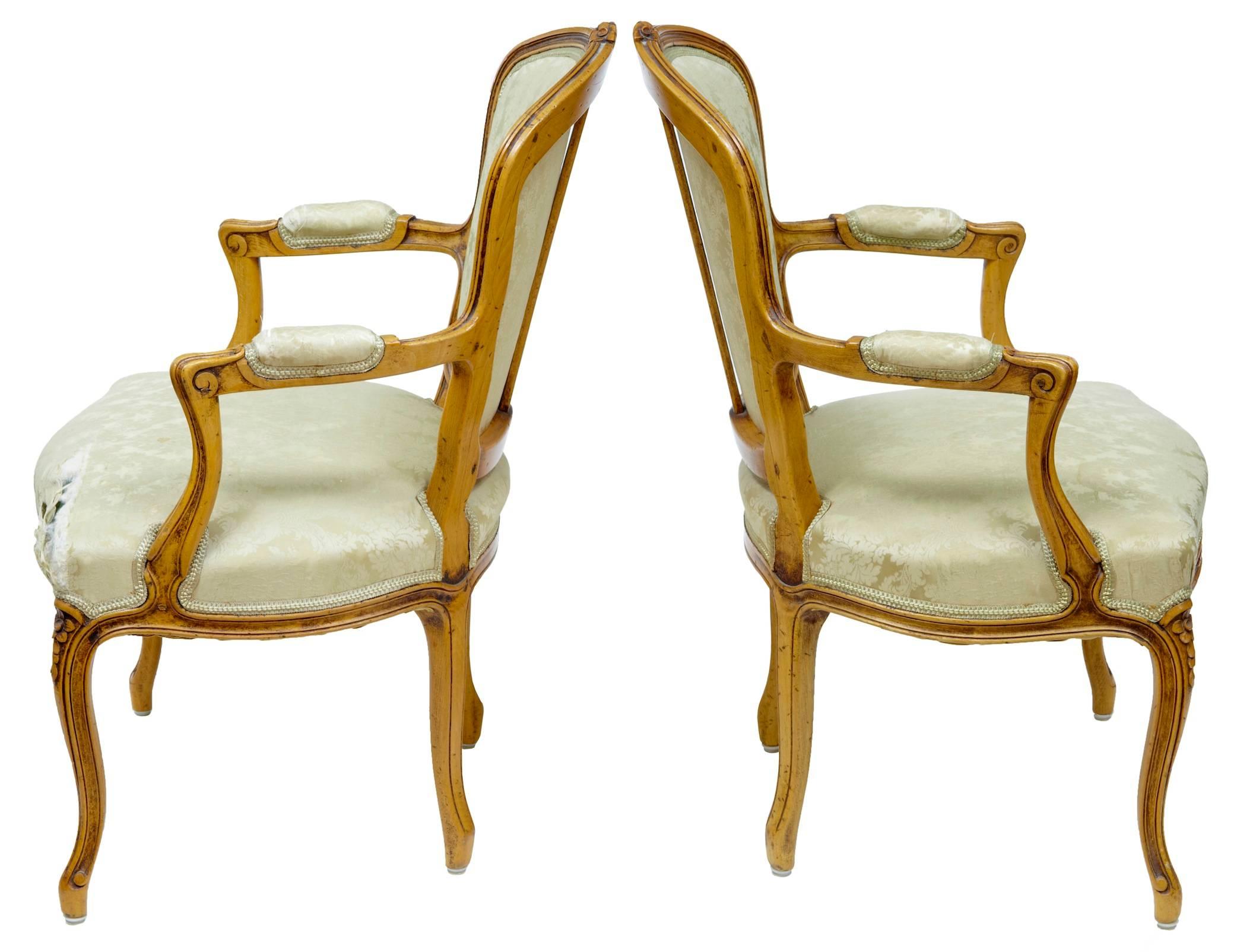 Excellent quality pair of French armchairs, circa 1840. Faint traces of the original green/blue paint, this has been later stripped to reveal a beautiful color beech, carved to the back and on the knee. In need of recovering as one corner is worn,