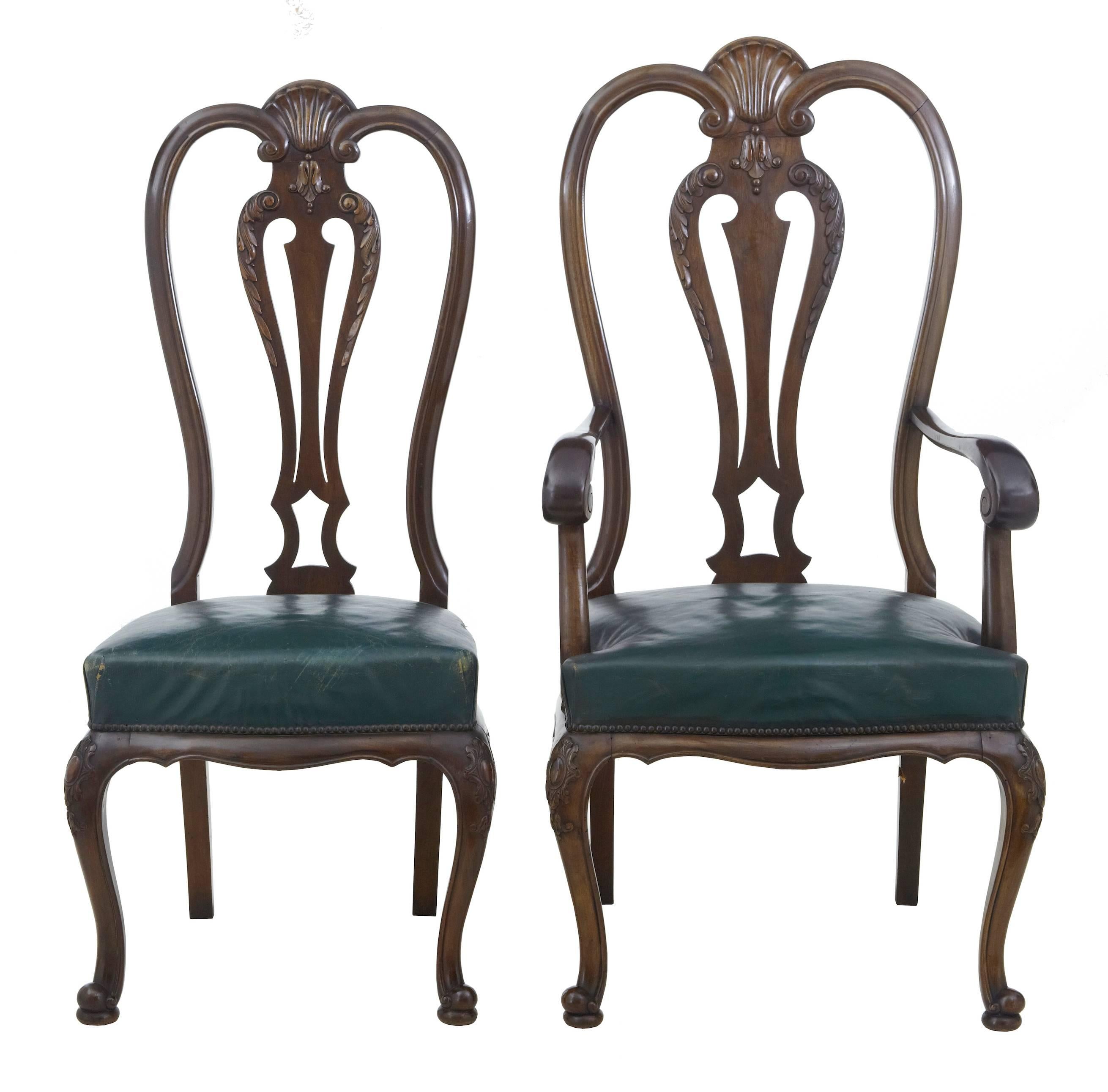 Striking set of mahogany dining chairs comprising of two carvers and six single chairs, circa 1900. Carved shells to the back rests, further swags to the back and knee. Over stuffed green leather seats which are need of some re webbing underneath.