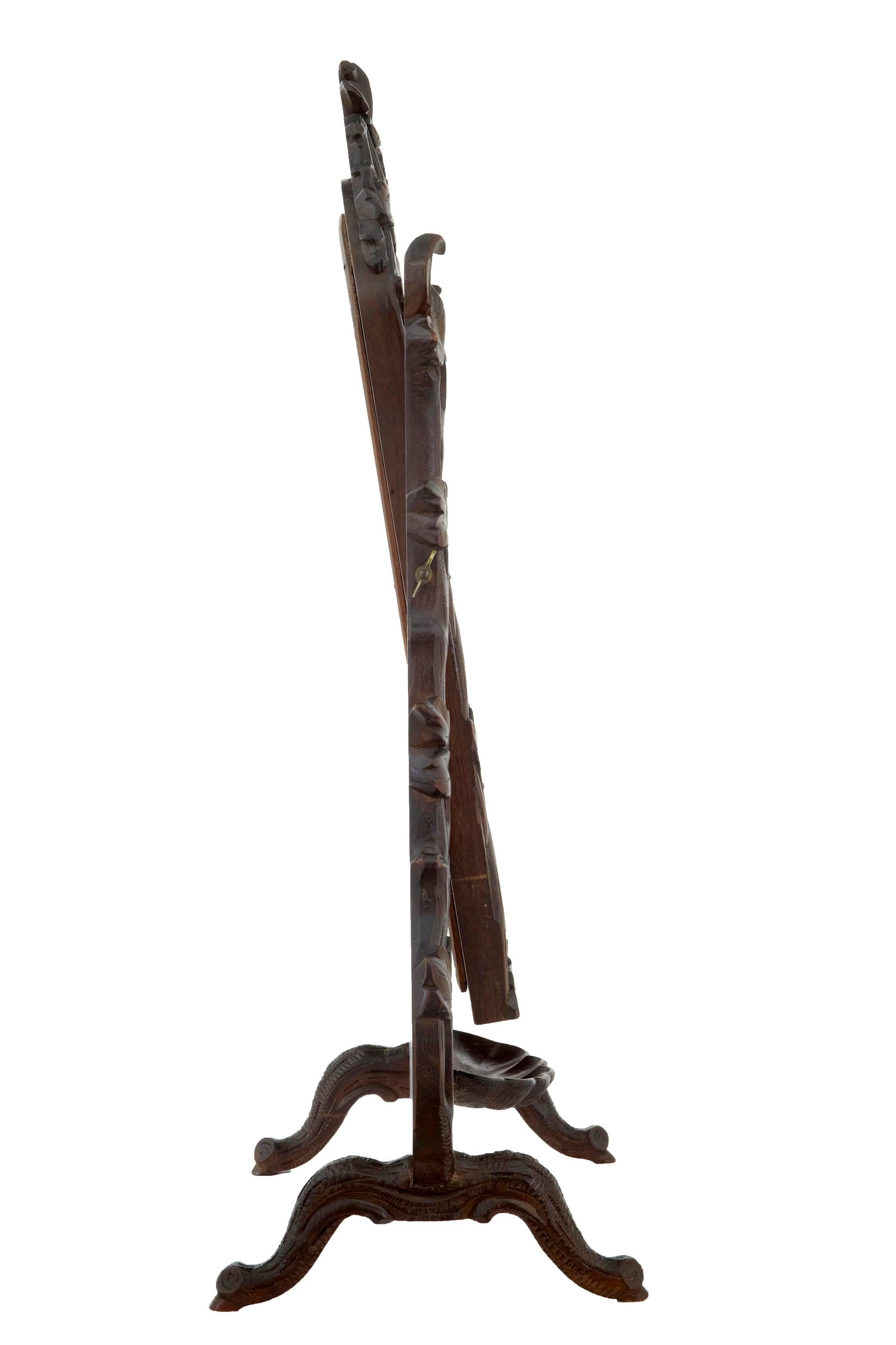 Carved Black Forest vanity mirror, circa 1890. Original plate. Carved shell below the mirror used for trinkets etc. Carved leaves and branches. Minor losses to carving, silvering to mirror. Restoration to shell cup.

Measures: Height: 27