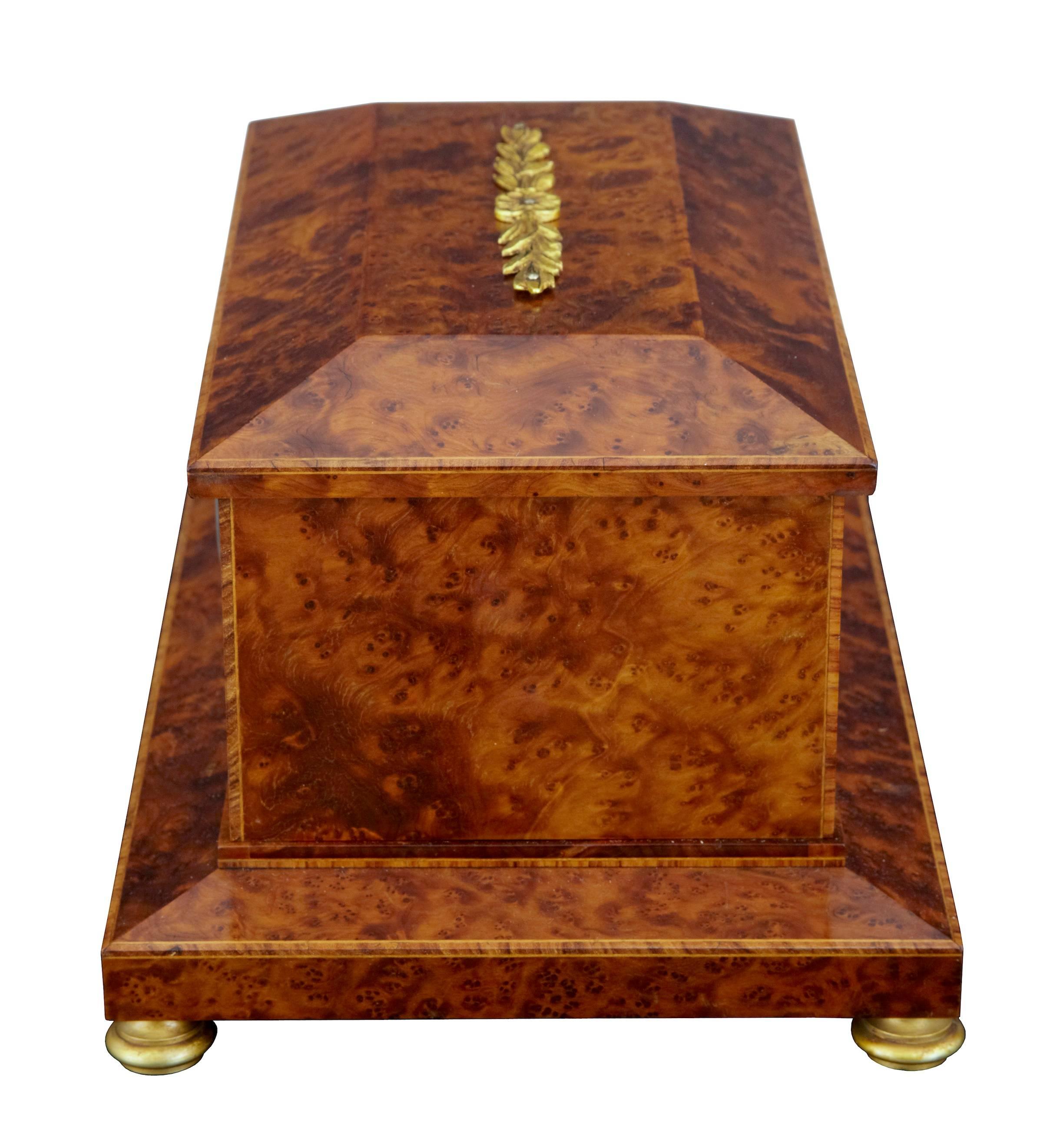 Good quality yew box in the empire taste, circa 1920. Strung and inlaid, with ormolu mounts and feet. Features an inset enamel clock movement. Desktop item, possible for use with cigars.

Measures: Height 6