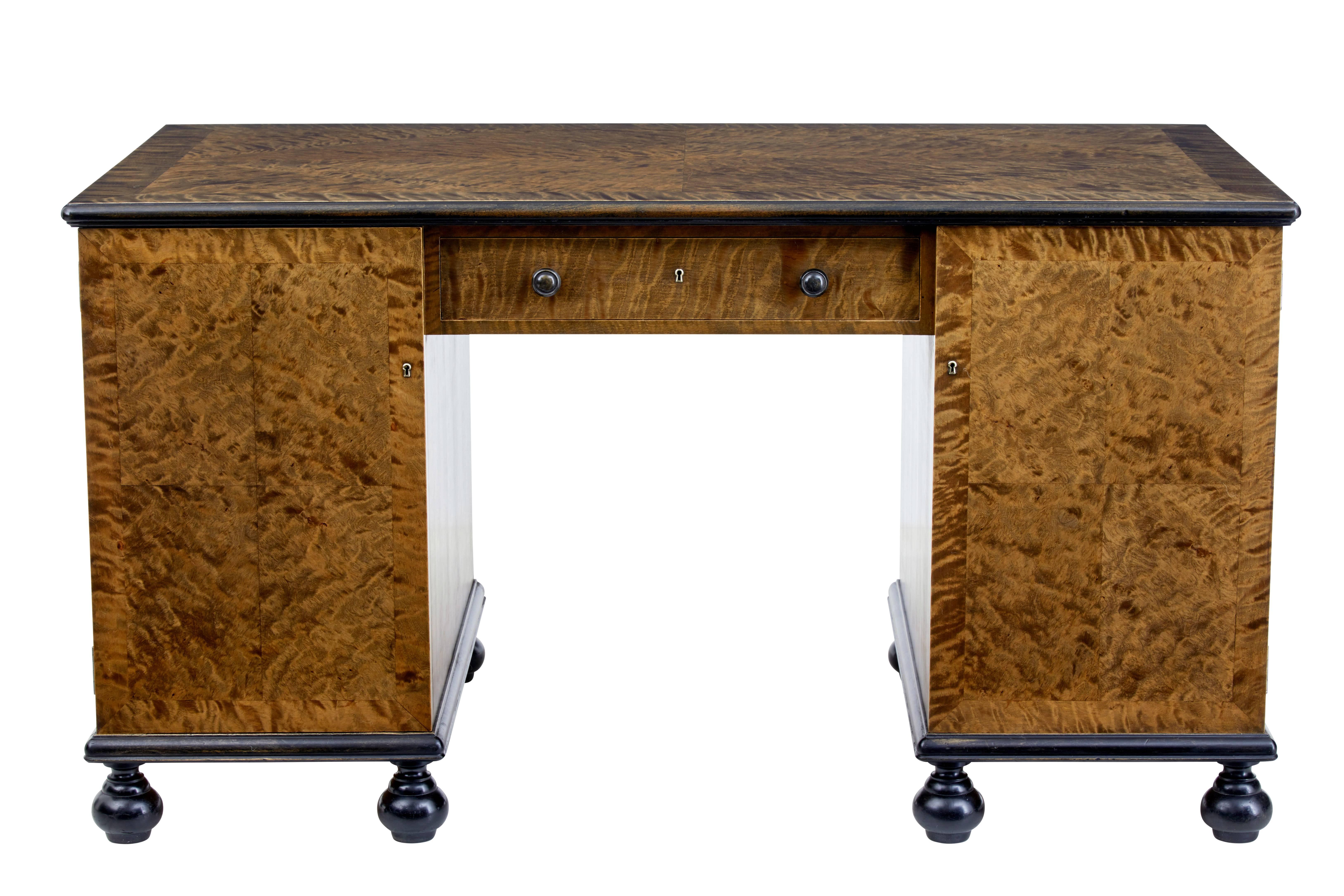 Beautiful quality one piece burr birch desk, circa 1930.

Fine quality striking burr timber used all round which allows this desk to be free standing.

Cross banded top surface with ebonized edge. Central drawer with turned handles above the
