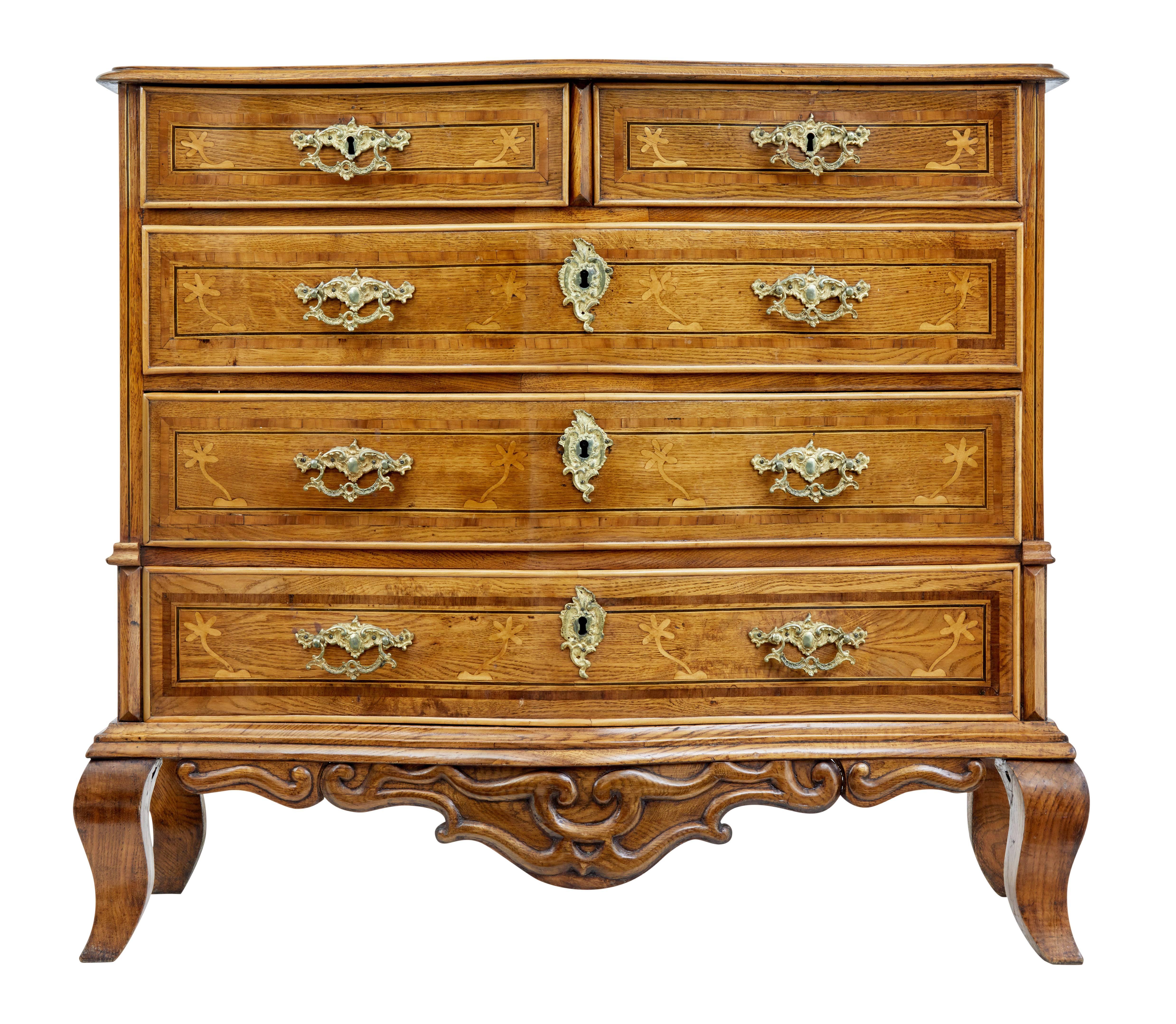 Rare Swedish oak two over three commode circa 1800.

Serpentine shape front, cock beaded edge drawers with stringing and inlay to the drawer fronts.

Inlaid birch design on the sides. Organic applied carving beneath the drawers and on the