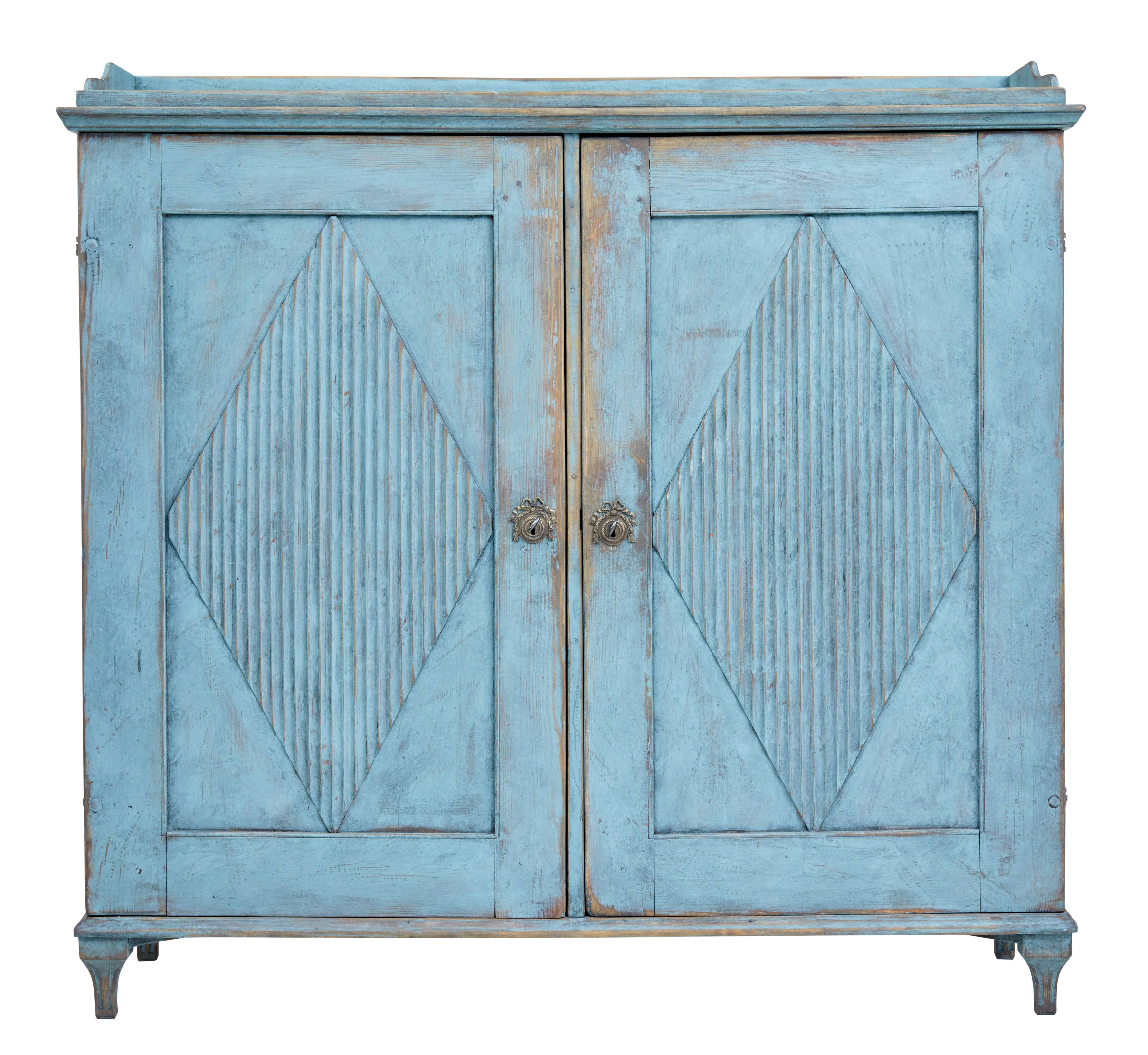 Fine quality Swedish pine cupboard, circa 1870.

Double door cupboard with applied fluted diamond shapes to the door.

Interior opens to a partial fitted interior of two drawers, a single shelf and narrow shelf either side of a central