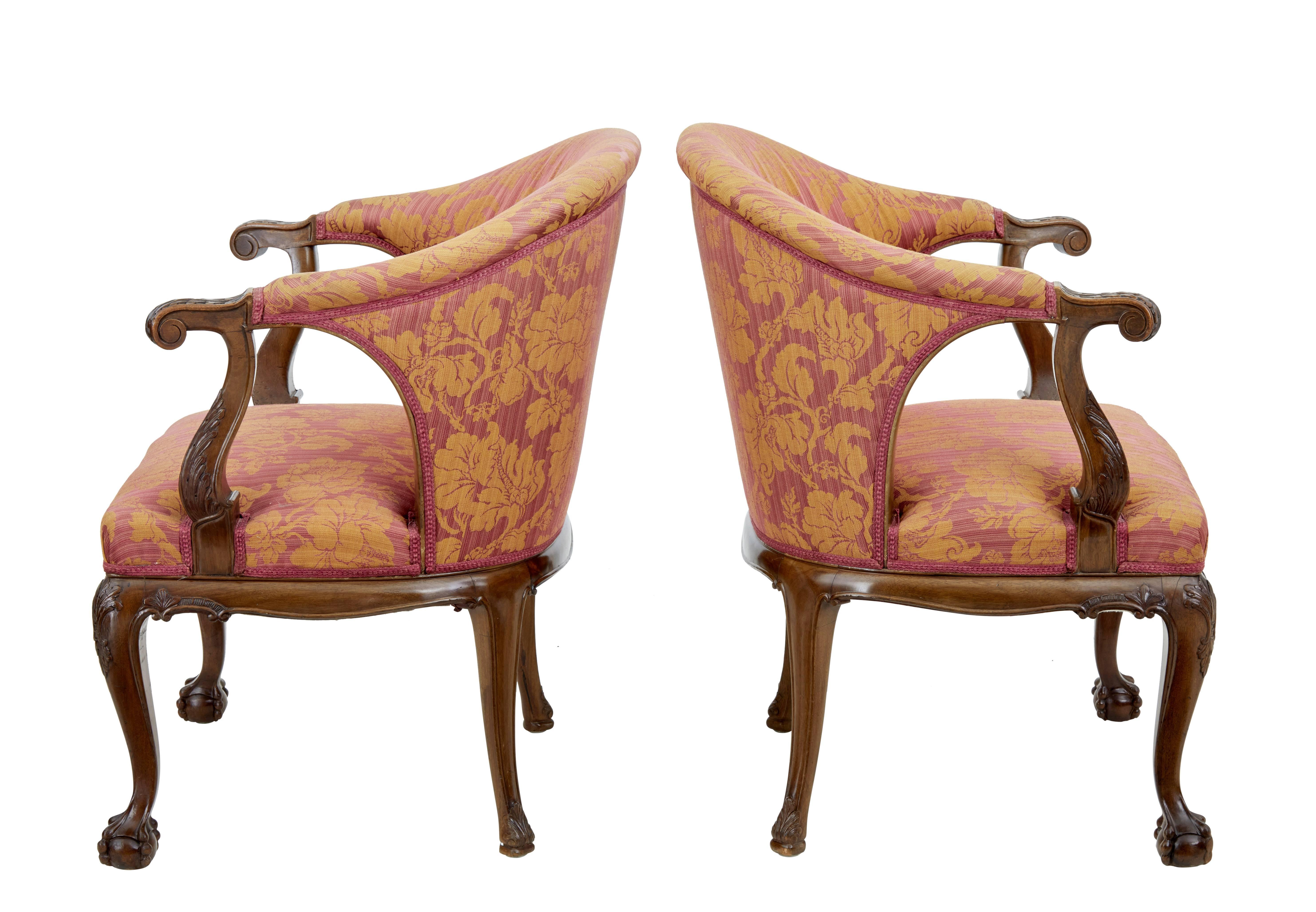 Fine pair of Georgian inspired club armchairs, circa 1900.

Shaped back rest with carved open arms showing acanthus leaves.

Carved underneath the seat with a shell and swags. Cabriole legs and standing on front ball and claw feet.

Fabric is