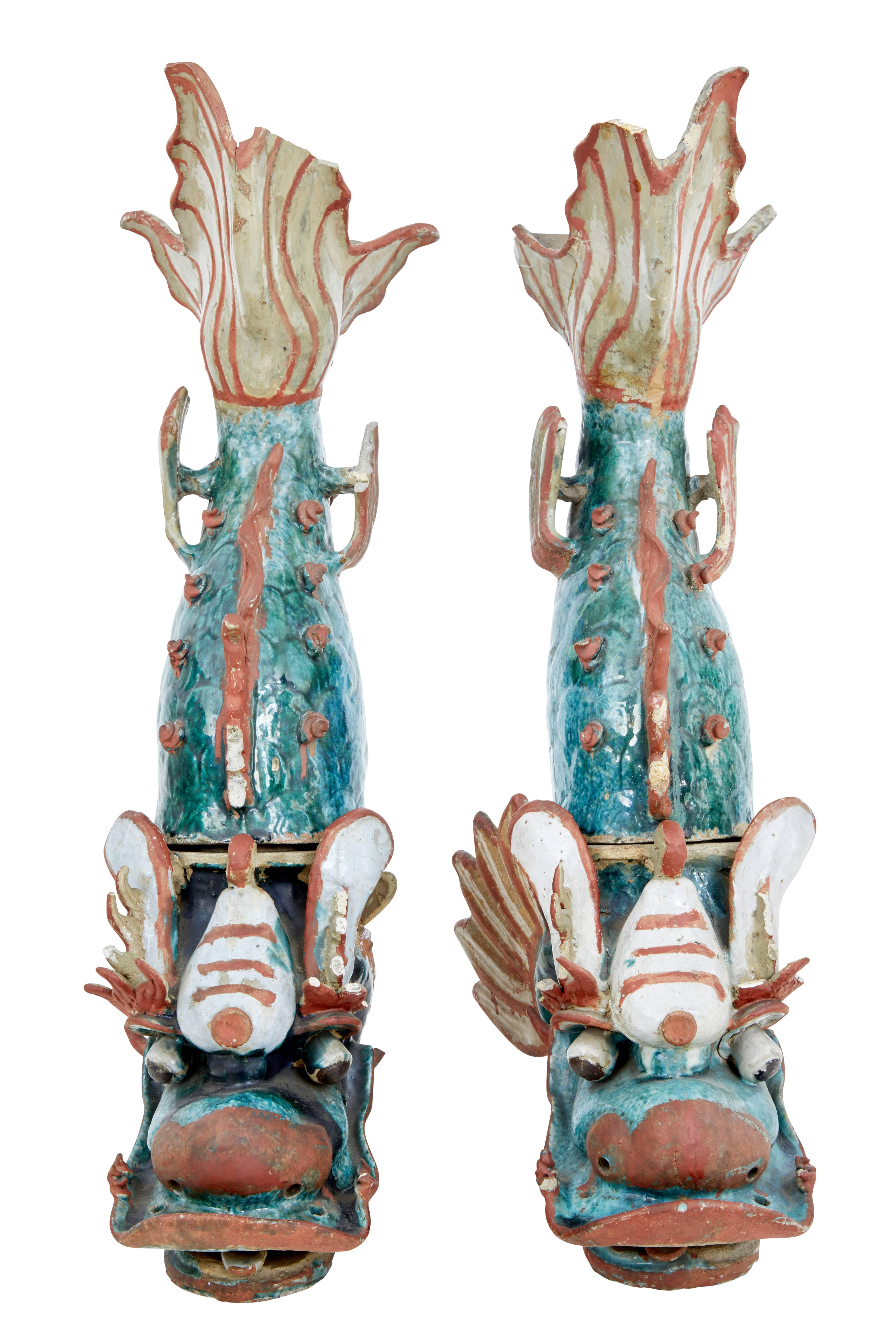 Striking pair of 19th century shachikoko roof ornaments, circa 1880.

These appear to be 'makara' sea monsters still retaining their bold colors.

Both are made from two sections and would have been originally nailed to the roof.

Because of