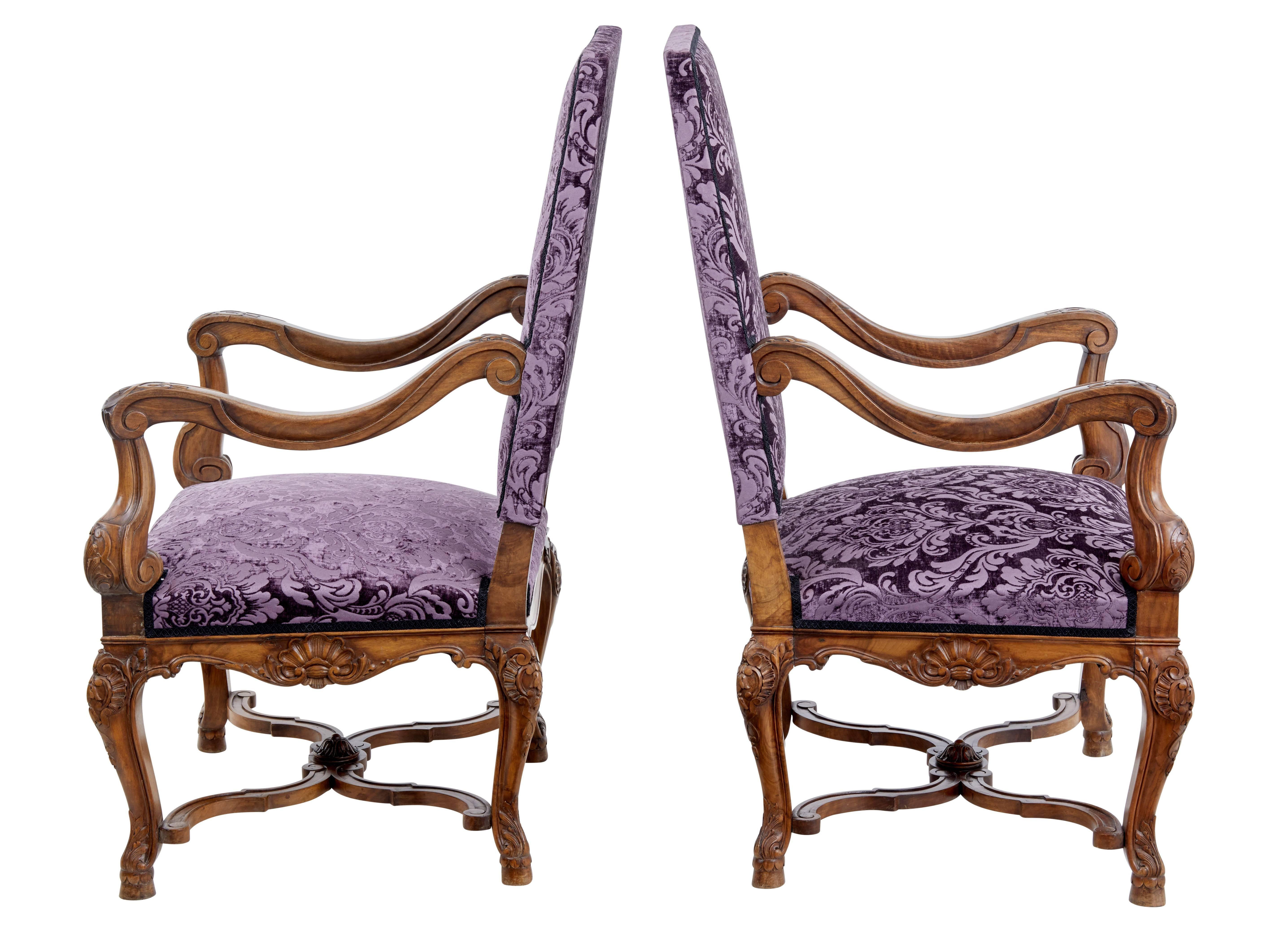 Delightful pair of French walnut armchairs.

With Art Nouveau carving to the arm, which flows all the way down the frame.

Good wide seat provides comfortable proportions.

Velvet flocked fabric is in good usable condition.

Cabriole legs