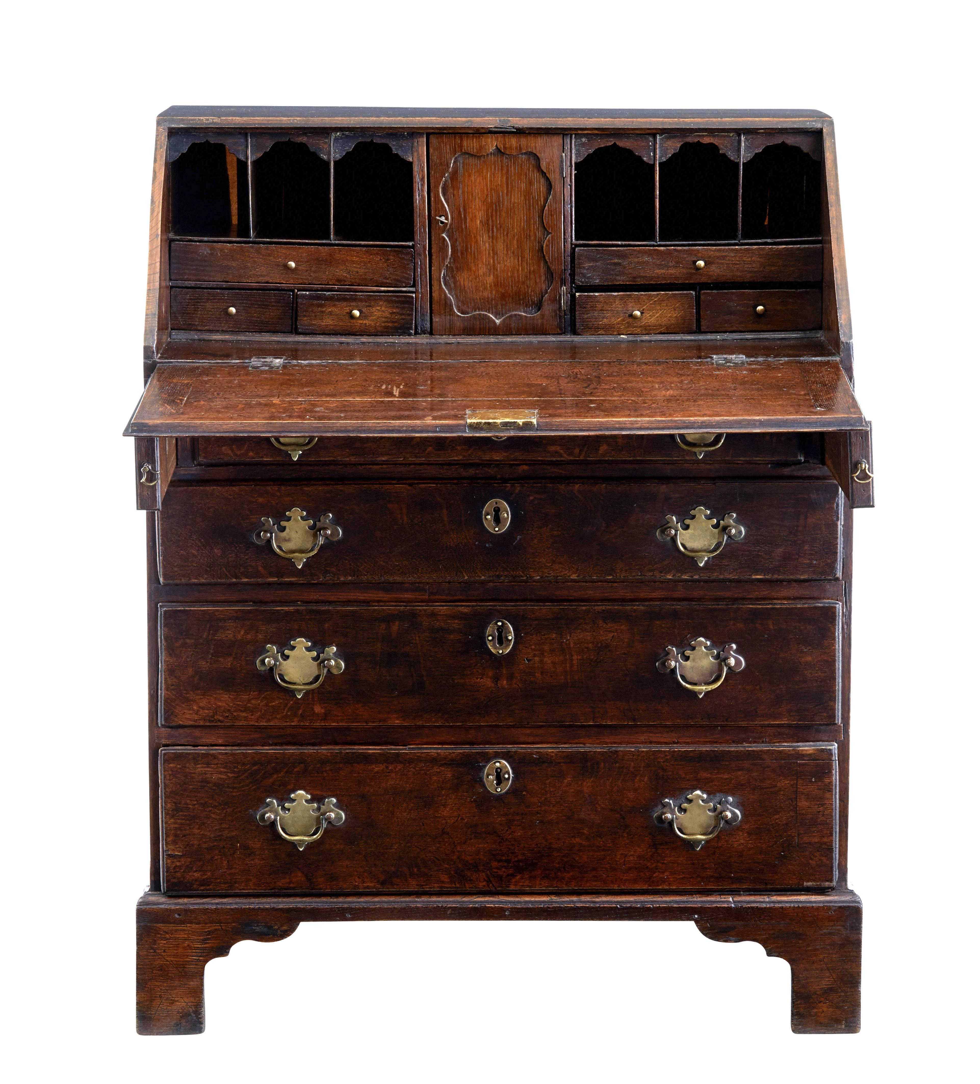 Delightful Georgian oak bureau of small proportions, circa 1740.

Fall drops to reveal a fitted interior of a central tabernacle flanked either side by pigeon holes and drawers.

Four graduating drawers to the front.

Standing on bracket