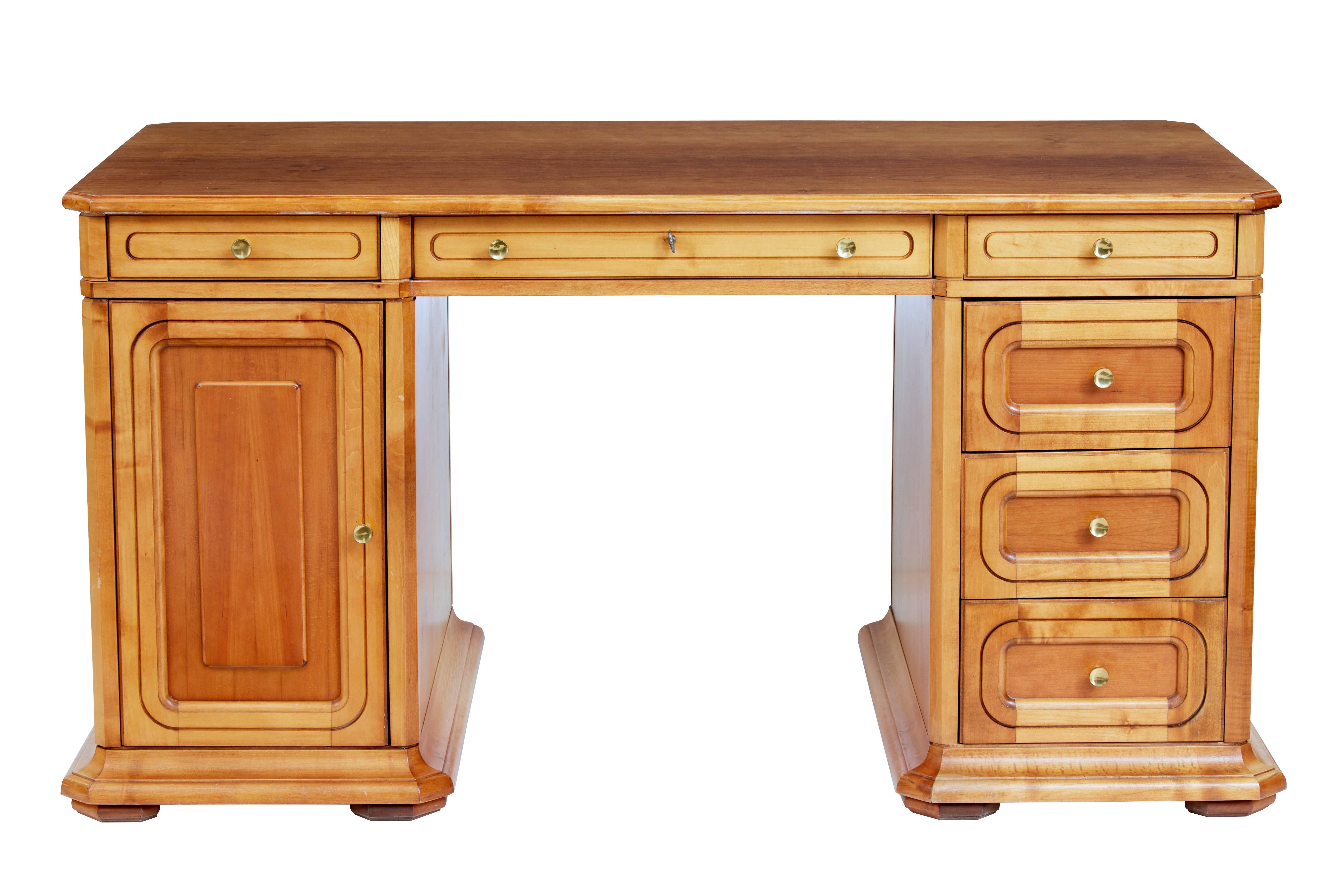 Scandinavian fruitwood freestanding desk, circa 1980

Functional piece of modern furniture with a re-polished top writing surface.

Three drawers below the writing surface, three drawers in the right hand pedestal and a cupboard with single